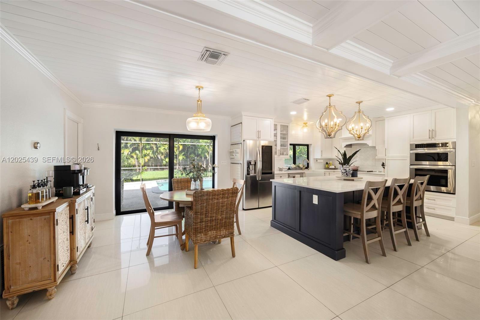 Tucked within the prestigious guard gated community of Kings Bay in Coral Gables, this beautifully updated 3 bedroom, 2 bath residence blends timeless coastal design with effortless everyday living. Set on an expansive 15,000 SF lot, the home features bright open living spaces, refined coastal-inspired finishes, soaring beamed ceilings, and a thoughtfully renovated kitchen with custom cabinetry, oversized island, and designer details throughout. The spacious layout flows seamlessly to the outdoor entertaining areas and private backyard, creating an inviting indoor-outdoor lifestyle synonymous with South Florida living. Residents of Kings Bay enjoy 24-hour guard-gated security along with exclusive marina and boat ramp access to Biscayne Bay, a rare opportunity for boating enthusiasts seeking both privacy and convenience in one of Coral Gables’ most desirable waterfront communities.
