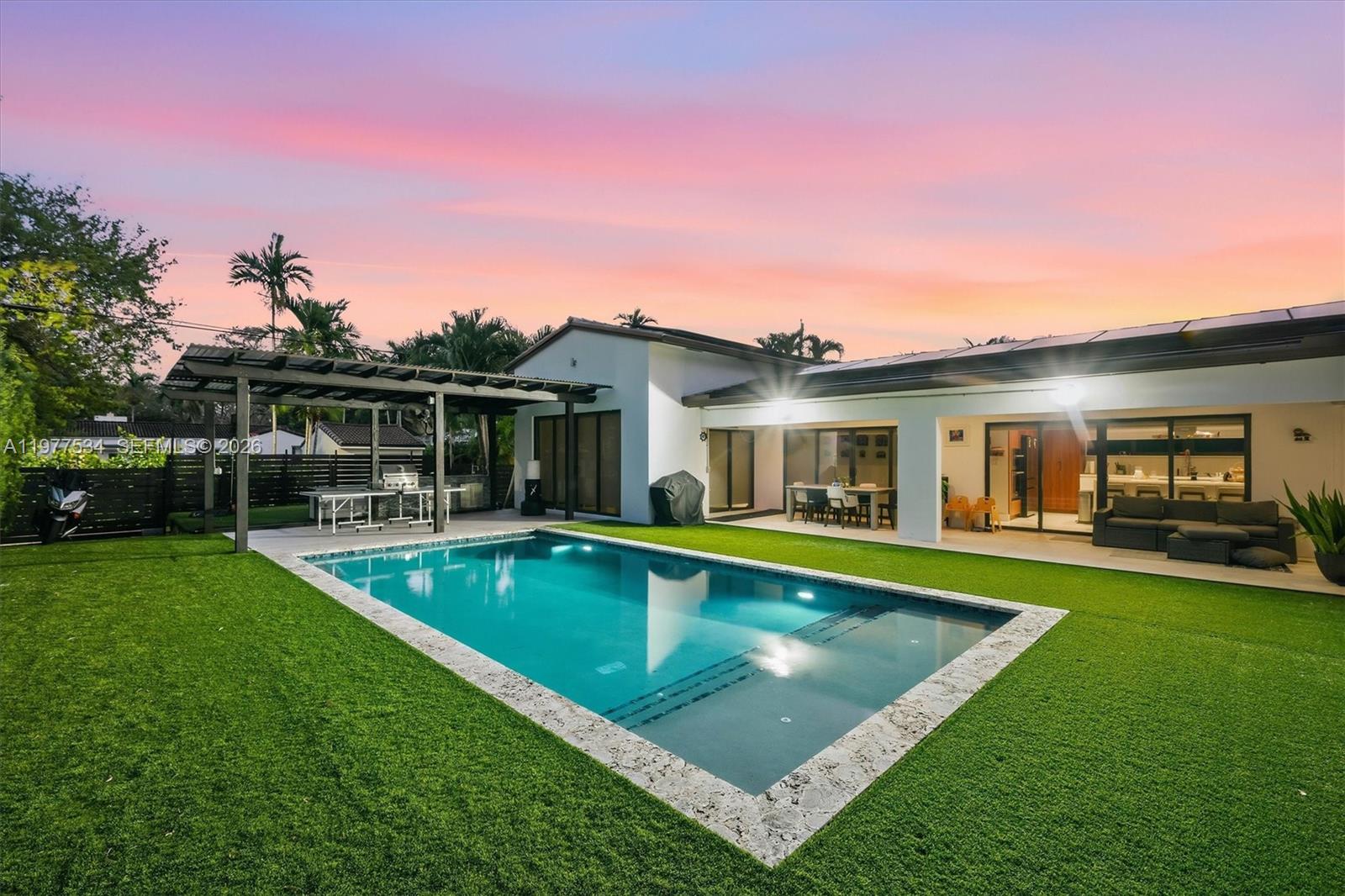 Introducing the Main Street Modern – A beautifully remodeled family home in the heart of Miami Shores, showcasing a striking white stone façade, and gated driveway with timeless curb appeal. Designed for today’s lifestyle, the home features a bright open layout and a spacious chef’s kitchen that flows effortlessly into the living and dining areas, perfect for both everyday living and entertaining.

Step outside to a private backyard retreat with a gorgeous pool and fully equipped outdoor kitchen, creating the ultimate setting for relaxing or hosting family and friends. Thoughtful upgrades include solar panels for energy efficiency and stylish finishes throughout.

Located on a main street in the Shores, this move-in ready home offers convenience, charm, and the perfect setting for family living just moments from parks, schools, and the vibrant Miami Shores Village.