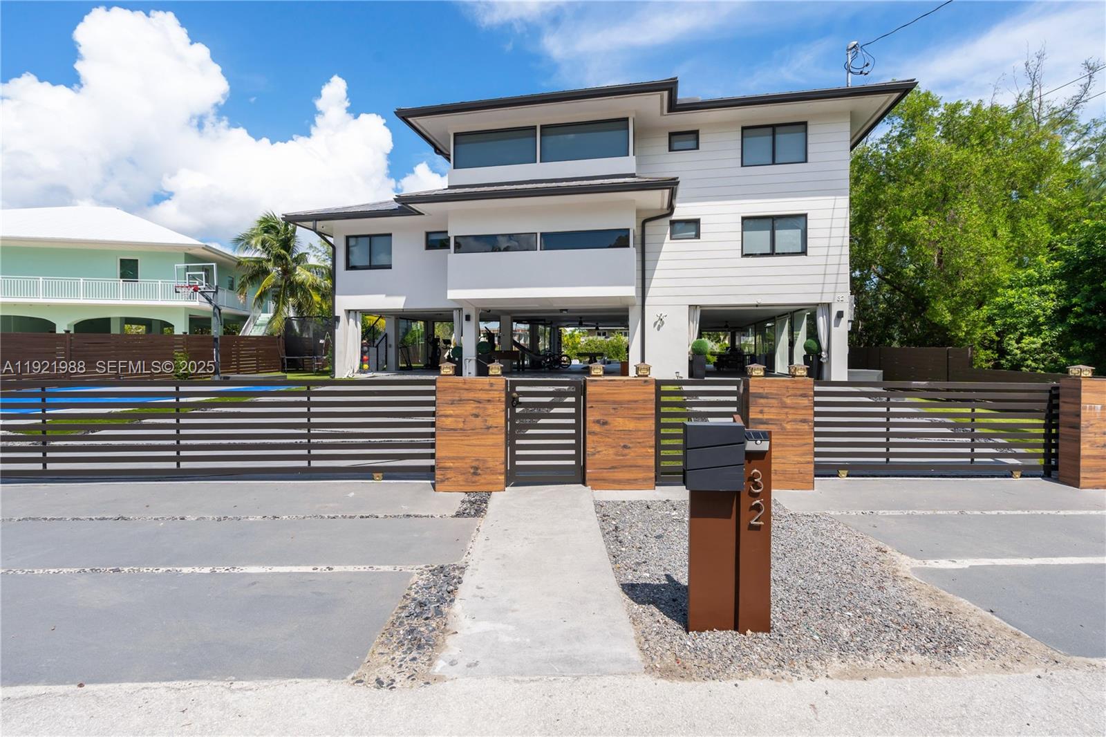Located in an exclusive area of the private Florida Keys, this immaculate 5-bedroom, 5-bath waterfront estate offers 3,846 sq. ft. of modern luxury and true resort-style living. Flooded with natural light, the home features dramatic double-height ceilings, polished marble floors, a designer great room, and an impressive home theater lounge. The gourmet kitchen showcases a massive island, premium appliances, and custom finishes throughout. Unmatched amenities include a fully equipped game level with foosball, ping pong, air hockey, arcade games, basketball arcade, and indoor/outdoor lounge spaces. A glass-enclosed fitness center and private sauna bring a premier wellness experience right into your home. Outdoors, enjoy a stunning waterfront pool with sun shelf and spa area, full outdoor kitchen, basketball court, trampoline, putting areas, kayaks, paddle boat, multiple terraces, and expansive entertainment zones—all overlooking peaceful Keys waterways. Beautifully styled bedroom suites with balconies and serene tropical views complete this one-of-a-kind retreat. Offering privacy, elegance, and endless entertainment, this home is a rare opportunity to own a modern luxury sanctuary in the coveted Florida Keys.