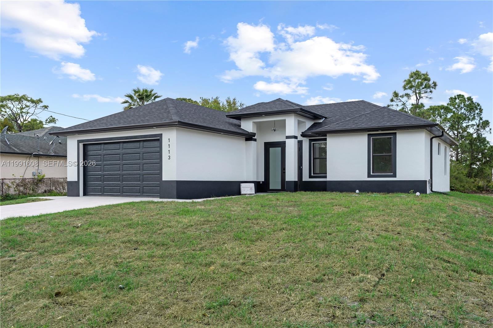 10K SELLER CREDIT FOR CLOSING COSTS!! Welcome to this beautifully crafted new construction home at 1113 Enrique St E, located in a fast-growing area of Lehigh Acres. This 3-bedroom, 3-bathroom residence offers modern design, quality finishes, and the added peace of mind of full impact-resistant windows and doors. Step inside to an open-concept layout filled with natural light, featuring a spacious living and dining area perfect for entertaining. The contemporary kitchen is equipped with sleek cabinetry, premium countertops, and stainless steel appliances. The primary suite provides a private retreat with a walk-in closet and a spa-like en-suite bath complete with dual vanities and a walk-in shower. Each additional bedroom is generously sized, with access to its own full bathroom—ideal for guests or flexible living arrangements. Enjoy Florida living year-round with a large backyard offering plenty of space for a pool or outdoor entertaining. Built with durability and efficiency in mind, impact windows and doors provide enhanced storm protection, energy efficiency, and insurance savings.