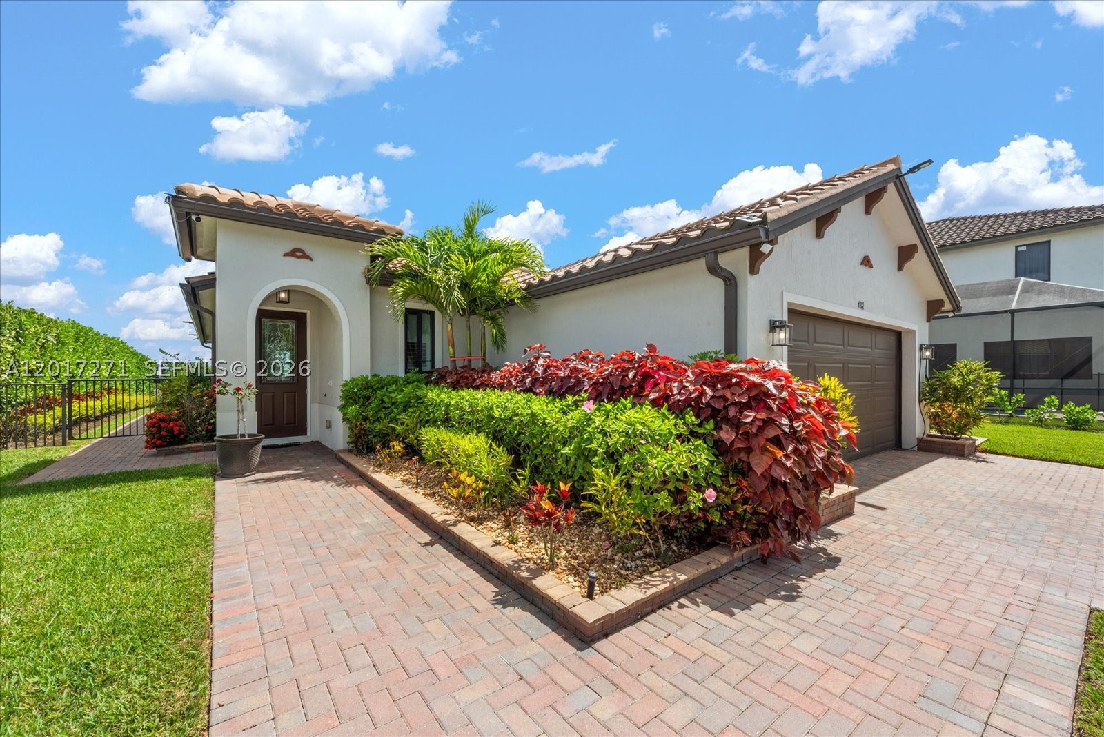 Located within the desirable Maple Ridge community of Ave Maria, this upgraded 2021-built spec residence offers a rare blend of modern comfort, energy efficiency, and lifestyle-driven living. Situated on a premium lakefront lot, this 3-bedroom, 2.5-bath home features 1,717 sqft of thoughtfully designed living space. This home has been extensively enhanced with high-value upgrades throughout, including high impact windows & sliding glass doors, plantation shutters, upgraded lighting, foam-sprayed attic insulation, and additional insulated living-space walls designed to improve energy efficiency and year-round comfort. Additional improvements include an advanced irrigation system, water softener, alarm system, roof-mounted Starlink connectivity, custom closets in bedrooms, and a hurricane-impact front door. Outdoor enhancements feature a custom extended brick driveway & walkways, upgraded landscaping with privacy plantings, underground gutter drainage system, HOA-approved fencing, and lake views from the premium oversized lot. Inside, the home offers a clean & modern layout designed for both comfort and functionality. The insulated garage includes a split A/C system, Tesla-EV charging station, custom flooring, and a 50-amp generator setup capable of powering the home during outages. The spacious backyard provides ample room for a future pool and expanded outdoor space. Residents of Maple Ridge can enjoy resort-style amenities, parks, walking paths, events, & top-rated schools.