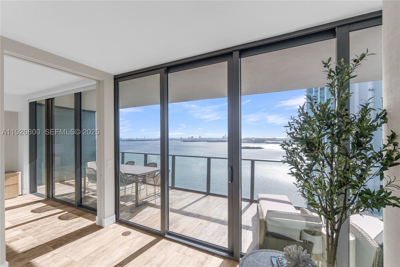 Panoramic ocean, bay, and skyline views within a thoughtfully designed, move-in-ready residence that delivers both impact and comfort from the moment you arrive. A private elevator opens directly into a bright, expansive layout with 9-foot ceilings and seamless indoor-outdoor flow, designed for effortless living and entertaining. The kitchen and living spaces have been fully upgraded with premium finishes and top-tier appliances, creating a clean, modern aesthetic that feels both refined and functional. Two oversized primary suites, each with direct balcony access, offer a true retreat experience, created to capture both sunrise and sunset. All four bedrooms feature en-suite baths and custom storage, blending thoughtful design with everyday practicality.  Set within a full-service luxury building, residents enjoy resort-style amenities including spa, tennis courts, golf course, bowling alley, and more. Positioned in one of Miami’s most connected locations, this residence is just minutes from the airport and moments from the Design District, Midtown, Wynwood, Miami Beach, and Aventura, placing you at the center of it all while still offering privacy, comfort, and long-term value.