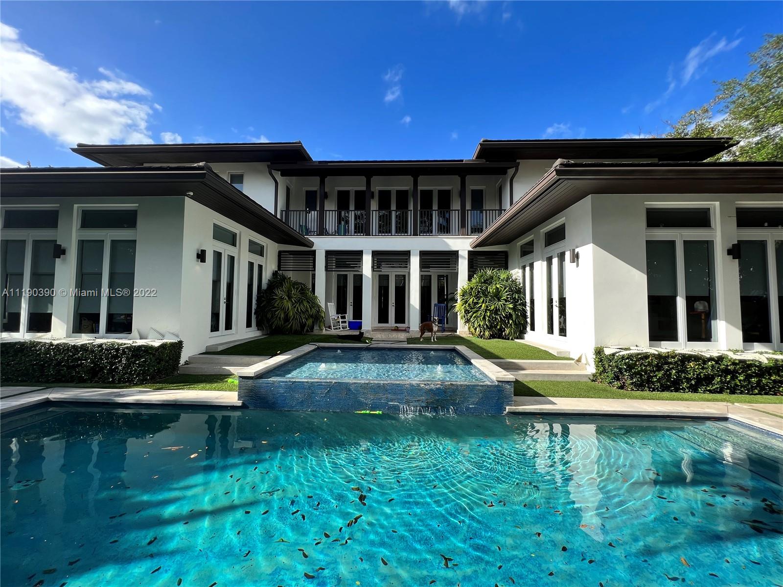 Contemporary masterpiece in the heart of South Miami. Built in 2016, this 4,786 SF, 6 bed, 6/1 bath home has it all. Luxurious open floor plan with volume ceilings and chef’s kitchen featuring gas stove, white stainless and quartz finishes. Grand first floor primary bedroom with large his/her closet and marble bathroom. Upstairs enjoy 4 en-suite bedrooms, additional family room and open balconies. Numerous smart home enhancements including Control 4, Nest, sound system and exterior security cameras throughout. Enjoy the ultimate Miami lifestyle by the heated pool and large outdoor kitchen or walk to your favorite parks, shops, and dining. Generator ready, 2 car garage and gated entry complete this stunning home. An absolute must see.