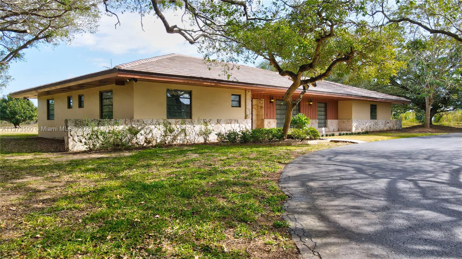 Location, location! Well built CBS home with flat tile roof. Beautiful street presence. Over 3000 plus sq ft hpme on 20 acres gross. Property has a large detached CBS garage and a second CBS equipment garage. Well maintained  home by one of the original Homesteaders of the area. Located in the Redlands. Excellent location, in desirable Redlands north quadrant, and minutes from US-1. Easy in and out, located on the corner of SW 248th St., "Coconut Palm", and SW 157th Av. "Newton". Rare opportunity for home and agricultural business. Large property that can be subdivided into 4 lots. Avocado/mango grove gives you income and agricultural status for taxes. The Redlands, Florida's last frontier, south Florida's last Agricultural land area. Located between the Florida Keys and greater Miami.