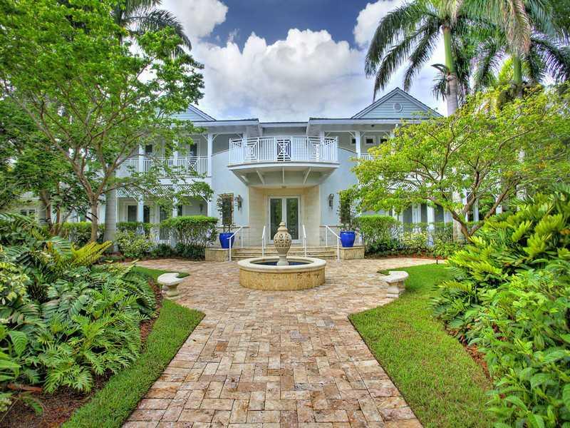 Beautiful custom built Key West style home situated on large, lusciously landscaped lot. Great floorplan with open spaces, high ceilings and impact windows throughout. Gourmet open kitchen, family room with bar area and separate office/guest house. Exquis ite finishes include handmade crown moldings, custom shutters, elevator and over 3,000 sq ft of covered wrap around balconies. Beautiful grounds w/ a summer kitchen, fountains, and covered terraces.
