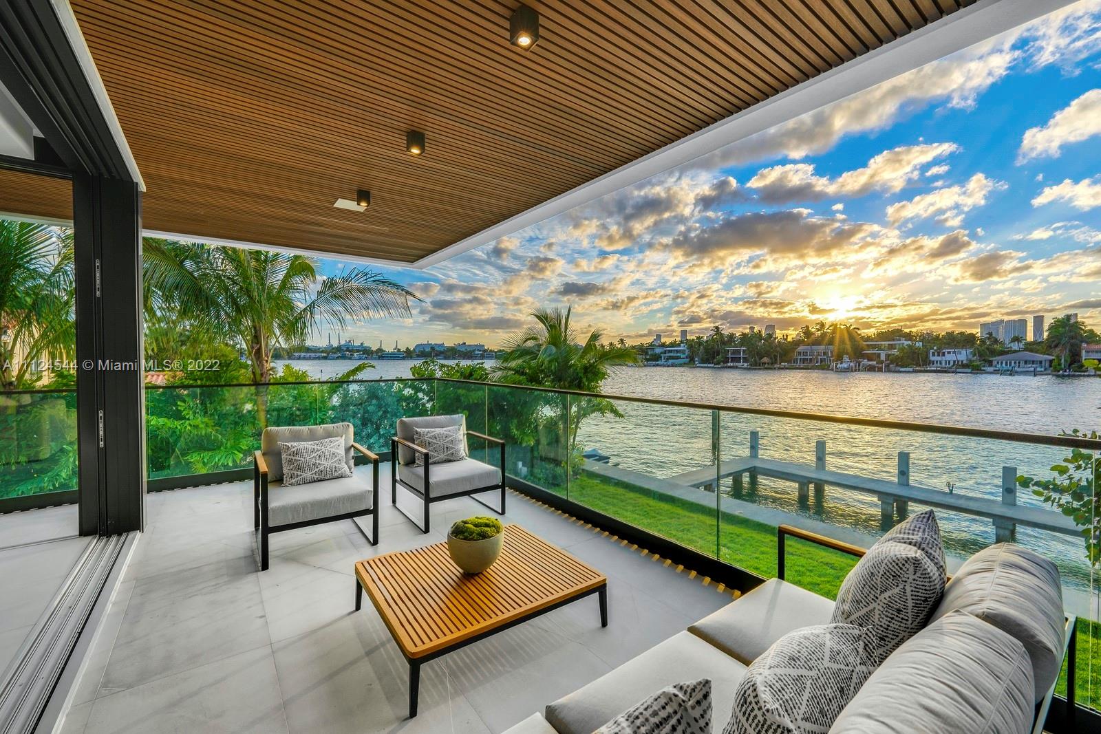 Masterfully designed & nestled amongst lush, serene landscaping, this brand-new tropical modern residence showcases a series of architectural moments, seamless indoor-outdoor living & an exquisite blend of luxurious materials, natural elements & breathtaking water views. As you enter this Venetian Island retreat, you’re greeted by a specimen tree surrounded by a water garden. Each space in this 5,500 SF, 3 story home is curated for ultimate enjoyment w/ open living spaces. Finishes completed to the highest level include white oak & marble floors throughout, Carrara marble accent walls, MiaCucina designed gourmet kitchen w/Statuario marble countertops. The home features an outdoor oasis w/ a custom outdoor kitchen, living + dining areas & a pool overlooking the private dock.