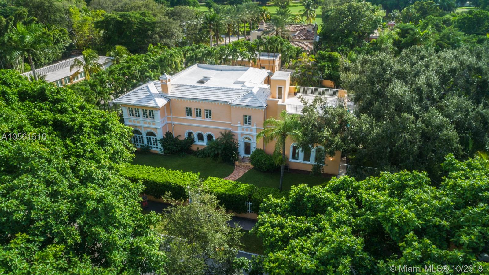 Located on iconic Alhambra Circle, this enchanting 1929 Coral Gables estate offers elegant living with Mediterranean Revival style architecture and hasn’t been offered for over 50 years! The gated triple lot offers 22,500 sf offers privacy, a picturesque oak tree, oversized 40-foot-long pool, & spectacular rooftop terrace.  Inside, the updated home designed by Anthony DeH Zink, has preserved historic features such as Cuban tiles, original hard wood floors, two fireplaces, arched windows & hallways, high ceilings & French doors throughout. Main house 5 large bedrooms, 4.5 baths, sunroom, formal living & dining, elevator, impact windows and living rooms both upstairs & downstairs. The detached structure has a dedicated room for a wine cellar, gym, additional room & upstairs 1/1 guest house.