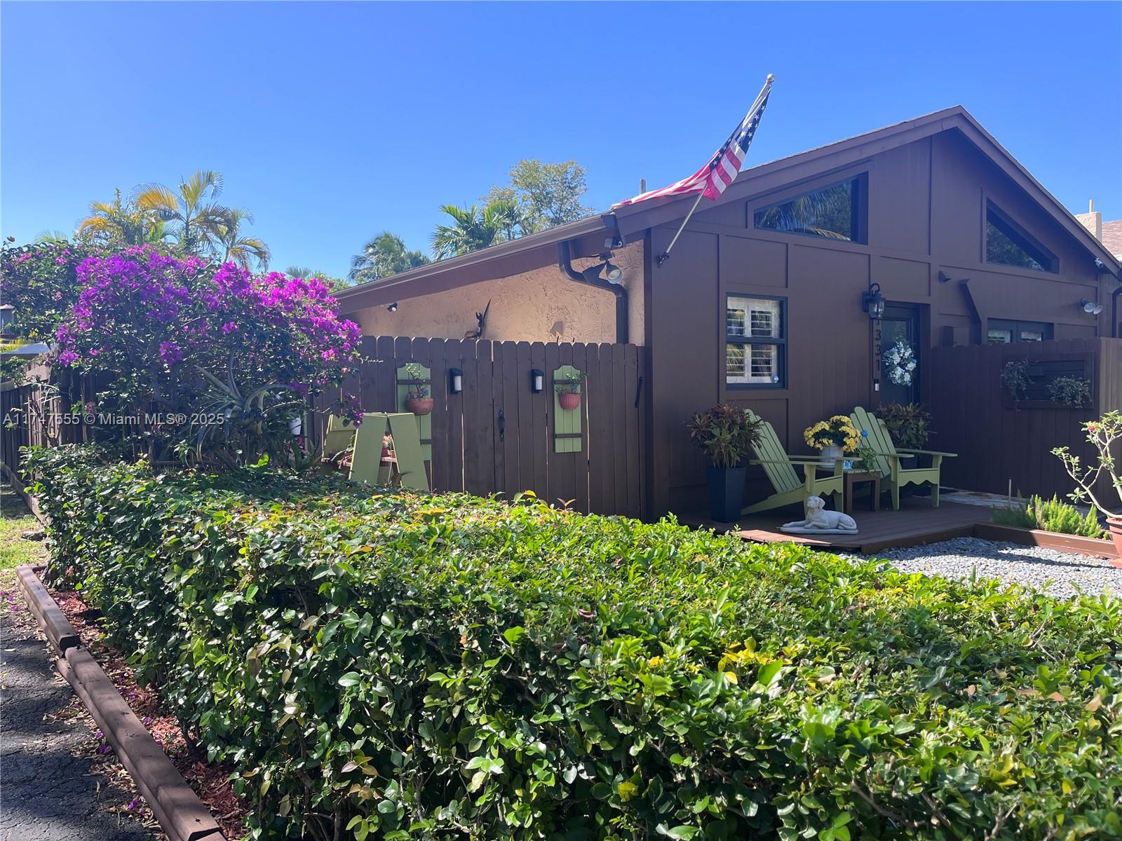 This remarkable townhouse has many upgrades, some include, new flooring, all windows and doors are impact glass, custom closets, new facade, concrete patio deck, and beautiful landscaping. The interior has 14 foot ceilings with exposed wood beams. Immaculately maintained. The pictures don't do it justice.  This is truly a gem.