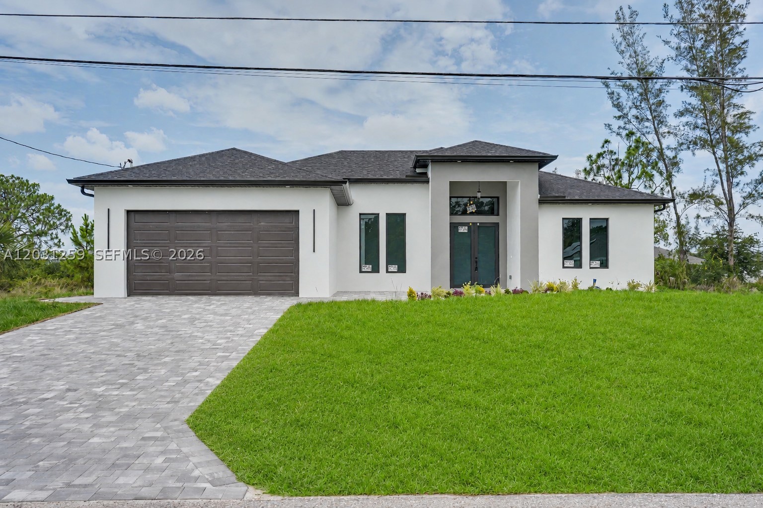 Not every new construction feels different. This one does. From the moment you walk in, the high ceilings, oversized doors, luxury finishes, waterfall quartz island, and custom floor-to-ceiling cabinetry set this home apart. The thoughtfully designed layout offers the perfect balance of openness, functionality, and everyday comfort. Step outside and enjoy peaceful canal views from your outdoor kitchen, complete with a cooktop, sink, and plenty of space for entertaining family and friends. A rare feature in this price range: two true master suites, each with its own private bathroom, providing flexibility for guests, extended family, or multigenerational living. Located in one of the fastest-growing areas of Northeast Cape Coral.