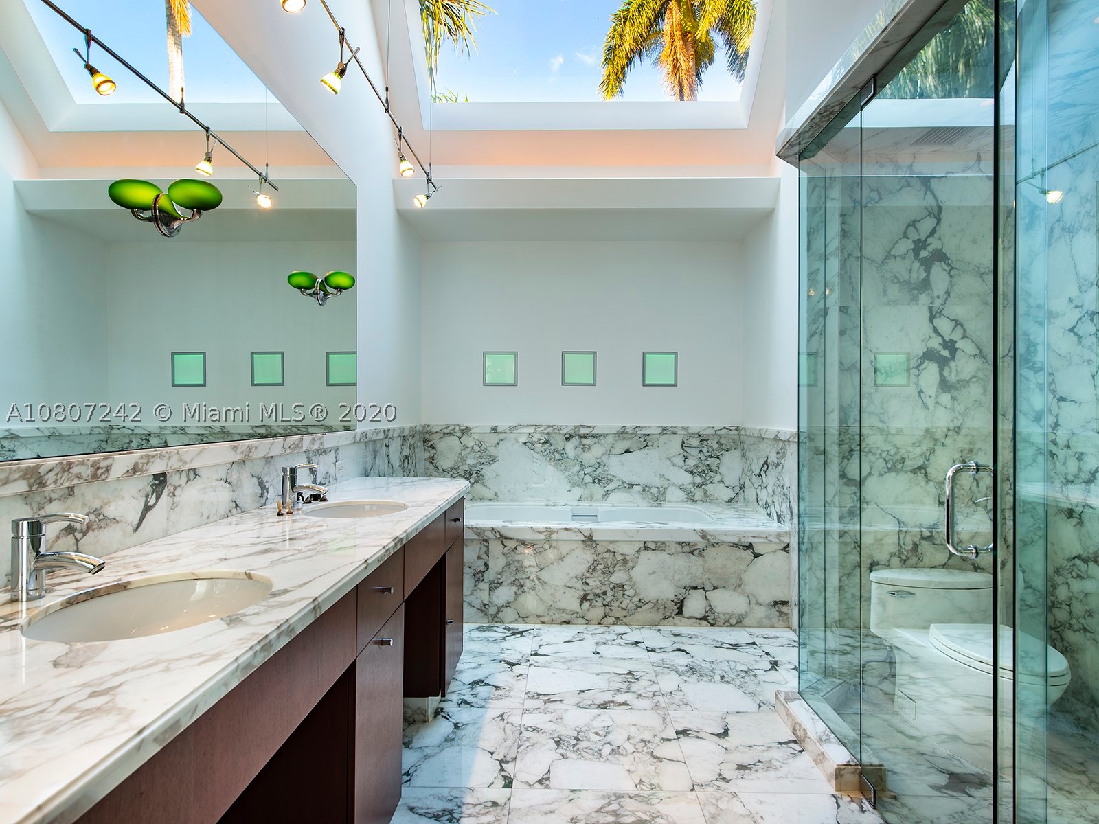With spacious interiors and large surrounding greenery, this stunning Miami Beach waterfront home includes 5 Bed / 4.5 Bath situated on a large 14,875 ft lot with 177 ft of waterfront. Constructed with contemporary architectural design, this 4,049 sq. ft. home features an expansive open living area with natural light everywhere, silver travertine floors, gourmet eat-in kitchen, customized stainless-steel staircase, and crema marfil marble throughout second story floors. Other amenities include floor-to-ceiling windows, a keystone terrace/patio for entertaining, an expansive backyard, a sparkling pool, and a private dock! Located on coveted gated Sunset Island 3, this exclusive home is within easy walking distance from the stylish Sunset Harbour neighborhood.