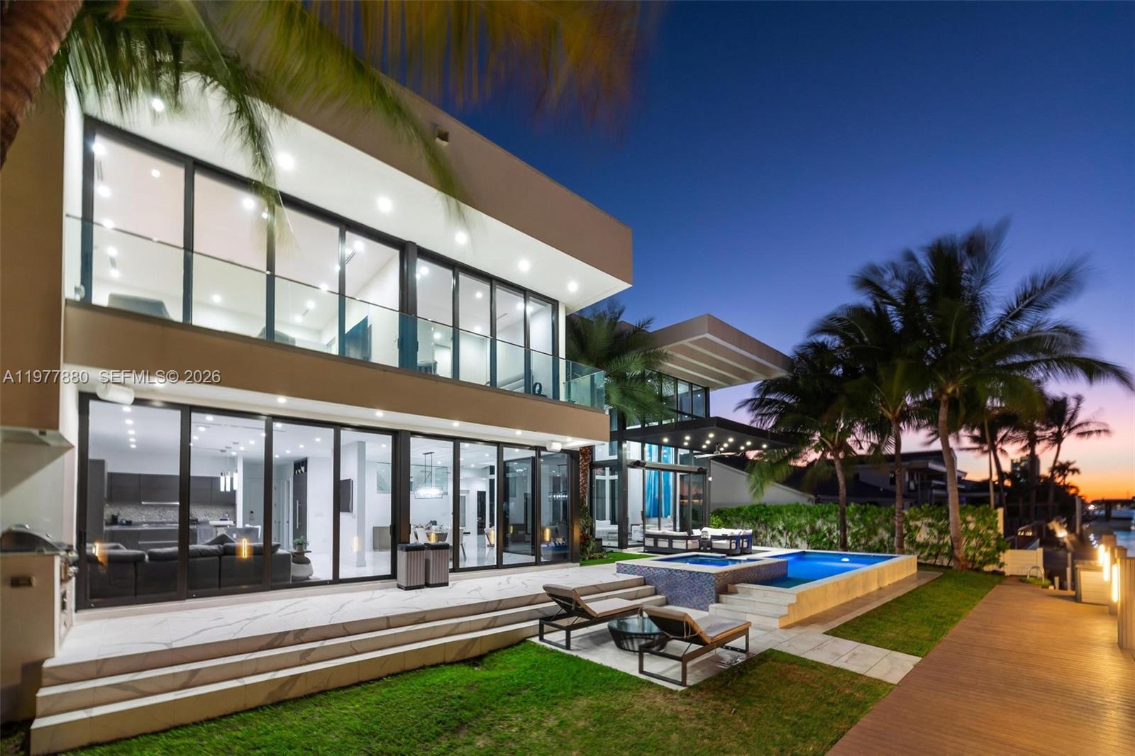 Experience the pinnacle of contemporary waterfront living in this newly constructed masterpiece located in the prestigious Eastern Shores community. Designed for both avid boaters and those seeking refined luxury, this extraordinary residence offers waterfront living with no bridges to the bay, providing effortless access to open waters. Spanning 5700 square feet, the home showcases dramatic double-height ceilings and expansive floor-to-ceiling glass, flooding the interiors with natural light while framing stunning water views. Multiple private balconies extend the living space outdoors, creating a seamless indoor-outdoor lifestyle. The thoughtfully designed chef’s kitchen features top-of-the-line appliances, custom cabinetry, and exquisite finishes. Spa-inspired bathrooms, exotic flooring, and impeccable craftsmanship elevate every detail of this modern estate. Enjoy resort-style amenities including a sparkling pool, summer kitchen, and private elevator. The residence offers 6 spacious bedrooms and 6.5 luxurious bathrooms, providing both comfort and functionality for family and guests alike. A rare opportunity to rent a sophisticated waterfront sanctuary in one of Miami’s most desirable boating communities.