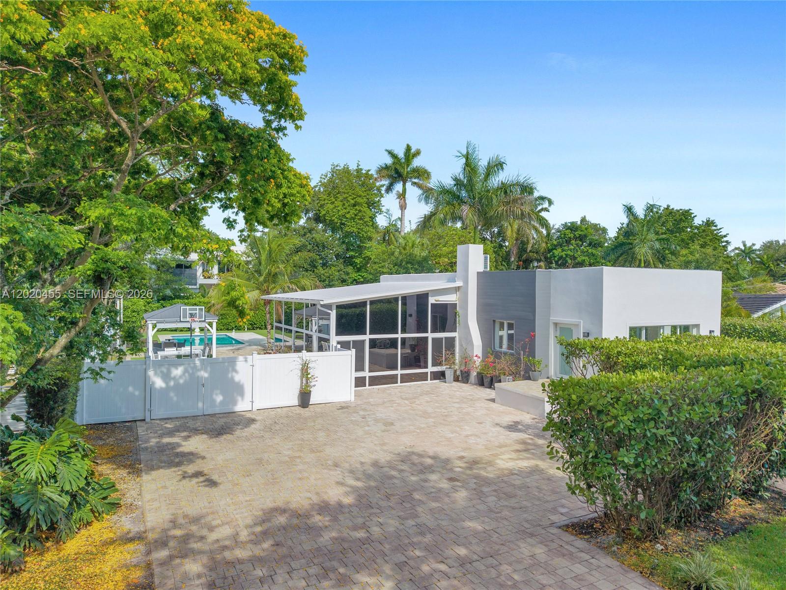 YOUR DREAM HOME AWAITS! Immerse in natural light in this 3/2 updated home with LARGE FL room. Nestled in the highly sought-after Village of Biscayne Park, this beautifully updated tropical retreat blends timeless charm with modern luxury on an oversized, fully fenced lot designed for entertaining and everyday enjoyment. Located on one of Miami’s most unique tree-lined neighborhoods known for its lush canopy streets, charm, and strong sense of community, this move-in-ready home offers privacy, character, and convenience just minutes from Miami Shores, beaches, Bal Harbour, Design District, dining, and major highways.

Step inside to spacious living areas filled with natural light and a massive hurricane-impact glass flex room, perfect as a family gathering room or multi-purpose space. SS modern appliances, kitchen island, and lots of storage. Large Dinning area and comfortable living room. Thoughtfully upgraded throughout, the home seamlessly blends indoor and outdoor living. 

Enjoy your own private oasis featuring a large resort-style pool, expansive maintenance-friendly turf backyard, fruit trees lining the perimeter, and a covered BBQ/gazebo entertaining area. A dedicated pool half-bath adds convenience for guests, while the redesigned front exterior and updated driveway create exceptional curb appeal with lots of parking. Rare opportunity to own a turnkey home in one of Miami’s hidden gems.
