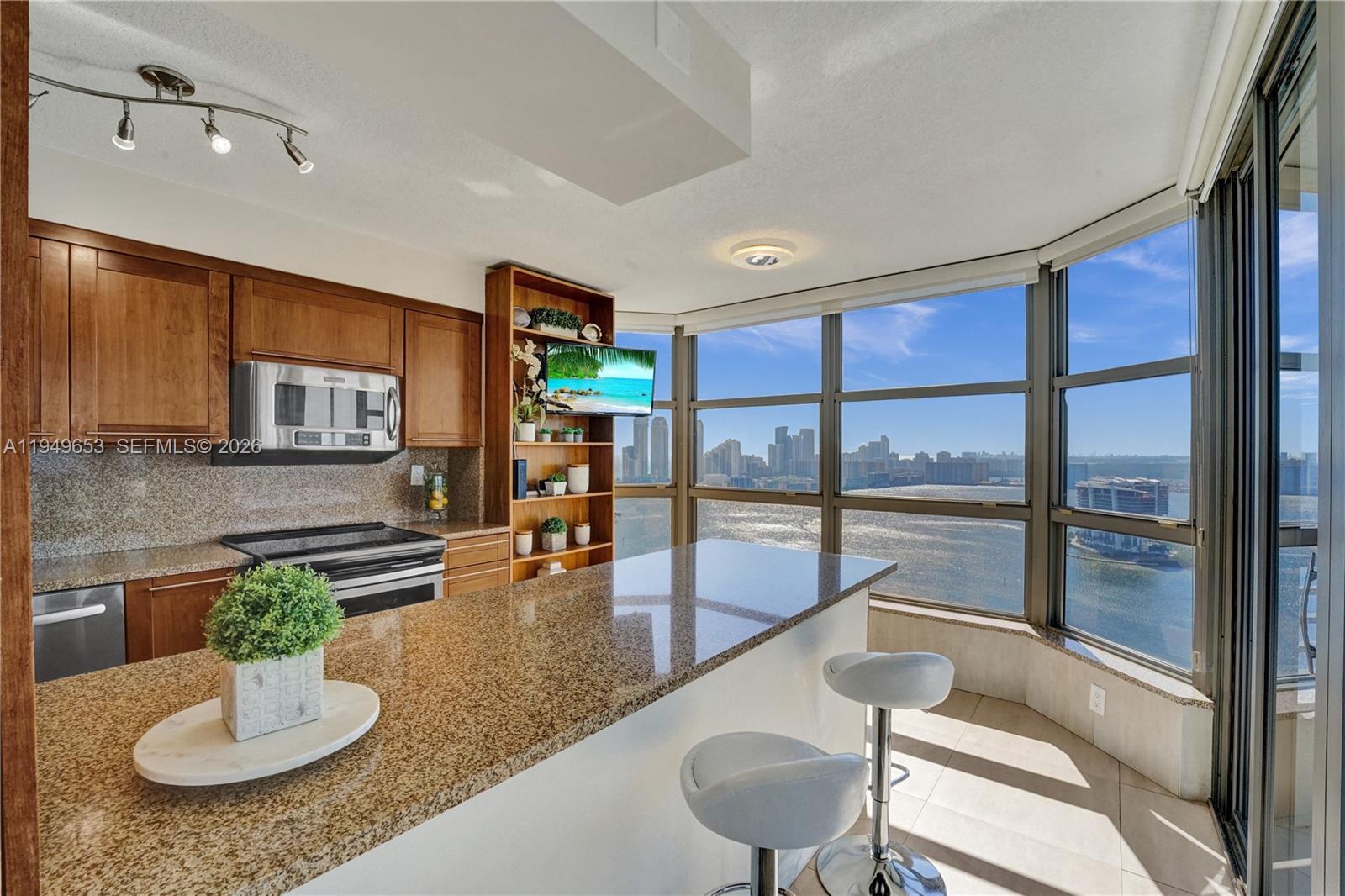 Enjoy spectacular and unobstructed east, south and west views of the ocean, Intracoastal, marina, golf course, city of Aventura, and Sunny Isles Beach from this beautifully remodeled and spacious three-bedroom, three-bath corner unit with wraparound balcony and 1,714 sq. ft. of living area. This condo is beautifully decorated, offered fully furnished, just bring your clothes. Features tile floors throughout. Open kitchen with stainless steel appliances, wood cabinets, granite counters, and backsplash. Separate-laundry room. Mystic Pointe, an all-inclusive, gated community providing an active lifestyle with eight lighted clay tennis courts, four lit Pickleball courts, paths along the bay, playground, mini market, restaurant, salon, dog-park and marina. It is located minutes from the Aventura Mall and beaches.