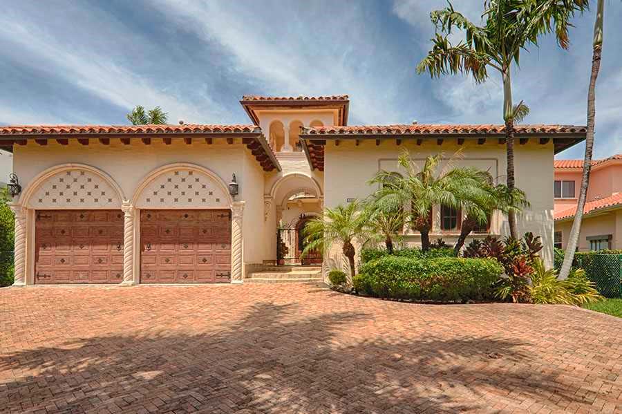 Stunning 5 BR/6.5 bath Mediterranean estate features 2 dens, large office, ample closets & balconies throughout. Greeted by a private courtyard & a 3 tier Italian fountain, this magnificent home has imported Honduras Mahogany doors, tiles handcrafted 1 by  1 in Colombia, Rojo Alicante marble floors & Comino Crespo wood detailed cabinets & furniture, gourmet custom Poggenpohl kitchen, eat in breakfast area, spacious wet bar w/custom wood finishes, pool, spa, cabana, dock, summer kitchen & 76' on the water.
