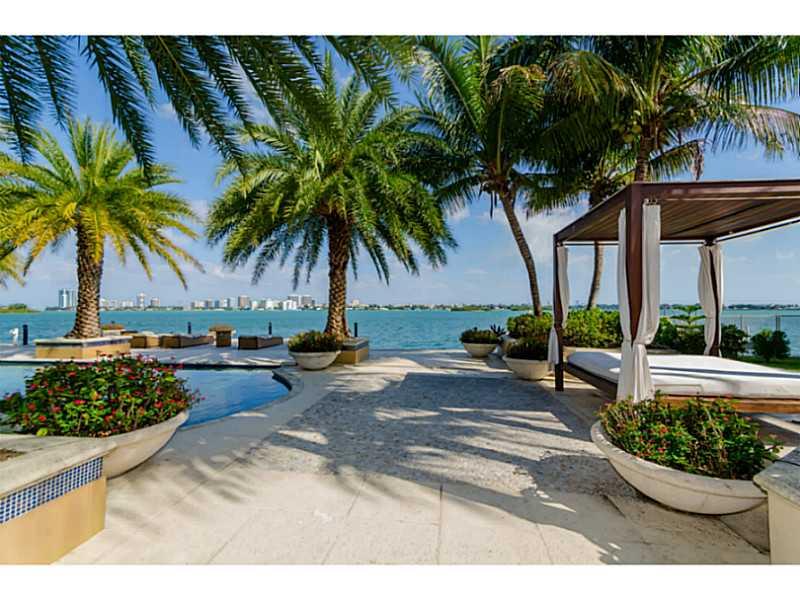 Grand estate with 150 FT on open bay! This waterfront estate sits on 22,500 SF lot w/ 9,000 SF (per appraisal) of interior luxury. Features include: entry w/ double volume ceilings; huge gourmet kitchen w/ gas stove; family room w/ wet bar; movie theater;  billiard room; gym; & wine storage. There is a huge master suite with sitting area & walk-in closet. The outdoors is a one of a kind paradise w/ heated pool, summer kitchen, wood burning pizza oven, guest house, children playground, dock  & boat lift.