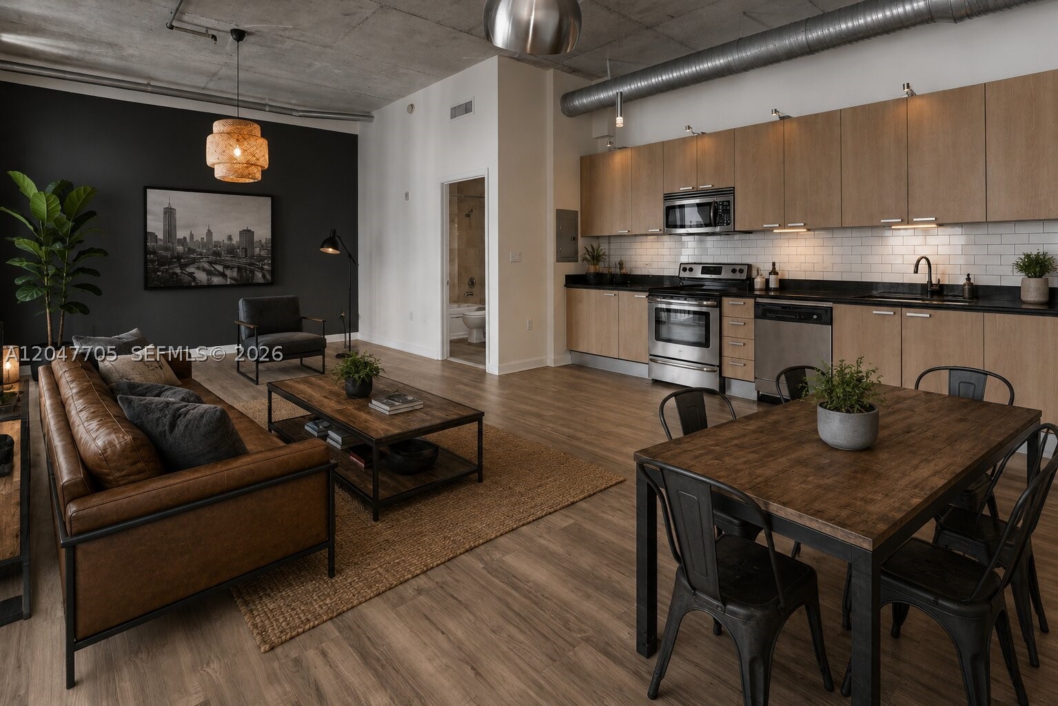 Experience modern loft living in the heart of Downtown Hollywood. This unique residence features a versatile two-bedroom loft-style layout with one fully enclosed bedroom and a spacious open loft that can serve as a second bedroom, home office, or creative space. The bright interior is enhanced by soaring ceilings, impact windows, and an open-concept design that maximizes natural light.

The contemporary kitchen is equipped with stainless steel appliances, granite countertops, and ample cabinetry, creating a functional space for everyday living and entertaining. Additional conveniences include covered garage parking, a private storage unit, and a bike storage room located just steps from the residence.

The building has recently undergone significant improvements, including concrete restoration, exterior painting, and refreshed common areas, providing added value and peace of mind. Residents also enjoy a secured lobby, community pool, and a prime walkable location just steps from Downtown Hollywood's vibrant restaurants, cafés, boutiques, entertainment, and weekly events. Ideally situated less than two miles from Hollywood Beach and only minutes to Fort Lauderdale-Hollywood International Airport, Aventura, Memorial Regional Hospital, Joe DiMaggio Children's Hospital, and major highways, this home offers the perfect combination of style, convenience, and South Florida living.