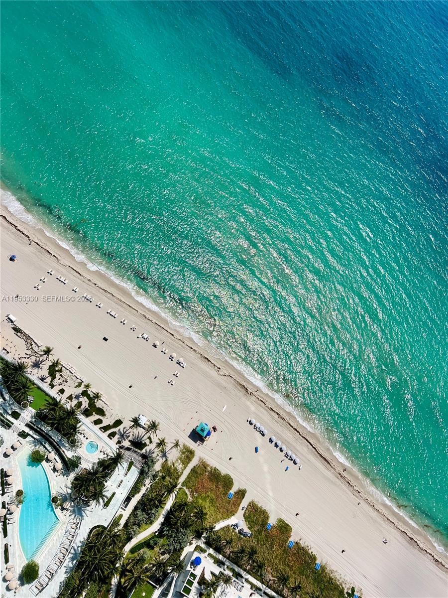 This Sky Home feels like living in a lower Penthouse with the most incredible views of ocean, bay and the Miami skyline.
Enjoy beautiful sunrises every morning overlooking the water from your expansive primary suite. 
Sophisticated 2-bedroom + office, 2.5-bath residence spanning 1,709 interior sq. ft. showcases breathtaking vistas through floor-to-ceiling glass and a spacious private terrace. 
Designed with elegant Giorgio Armani interiors, featuring a seamless open-concept layout, an Italian Armani Dada kitchen, top-of-the-line Sub-Zero and Wolf appliances, and exquisite finishes. 
Custom walk-in closets, a serene spa-inspired bathroom with soaking tub, dual vanities, and elegant marble detailing. Generously sized en-suite second bedroom provides comfort and privacy for guests or family. Work from home office perfectly set up in the den. 
Armani Casa Residents enjoy access to 30,000 sq ft of world-class amenities including cafe, restaurant, oceanfront fitness and spa. Located in the heart of Sunny Isles Beach just moments from fine dining, luxury shopping, and top-tier schools - delivering an exceptional beachfront lifestyle.
