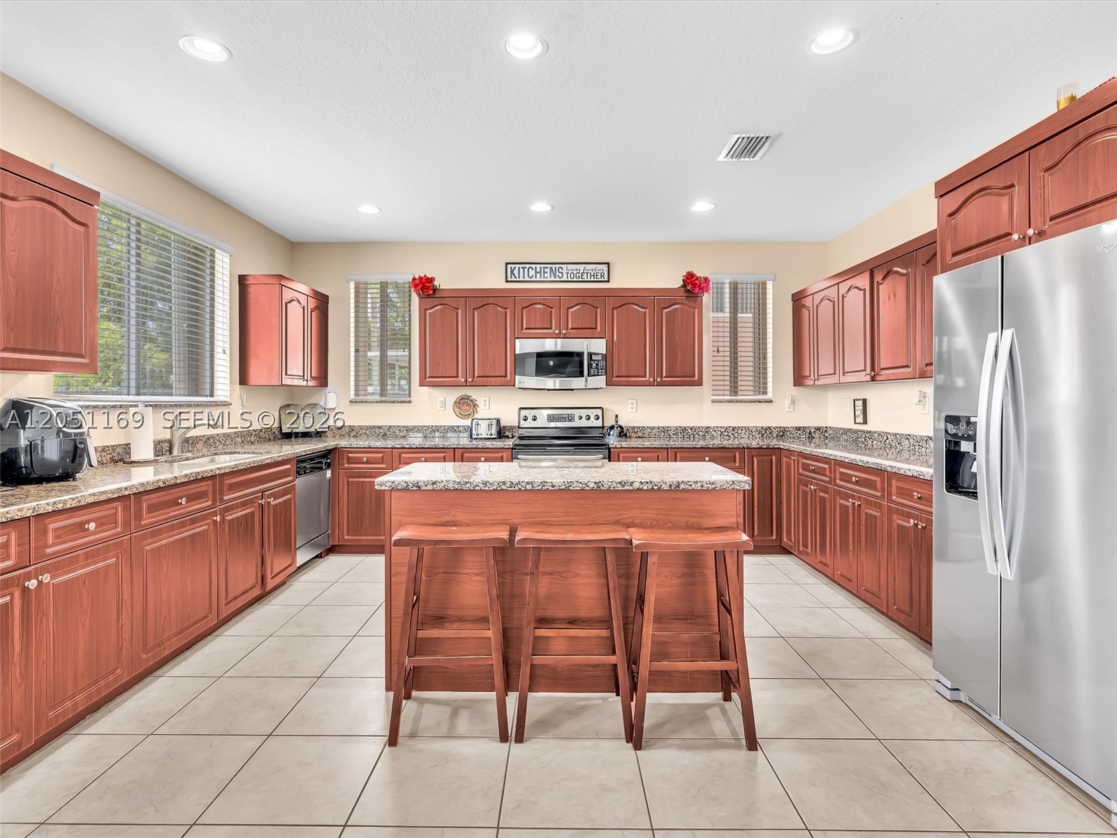 Space, light and room for everything in the sought-after Coconut Cay community of Miami Gardens. This exceptionally spacious two-story home offers over 3,300 total square feet with nearly 2,800 square feet of living area, 4 bedrooms, 2.5 bathrooms and an attached two-car garage. From the moment you walk in, soaring ceilings and abundant natural light open into an expansive floor plan made for family gatherings, holiday celebrations and everyday living. The oversized kitchen is the true heart of the home with generous prep, storage and gathering space flowing effortlessly into the main living and entertaining areas. Upstairs, spacious bedrooms feature wood flooring and large walk-in closets, while the primary suite offers ample closet space and a private bath with dual sinks. Additional highlights include tile flooring throughout the first floor, accordion hurricane shutters on the entire home and a Wi-Fi enabled garage door opener. And the location could not be hotter. Miami Gardens is home to Hard Rock Stadium, host of FIFA World Cup matches, the Formula 1 Miami Grand Prix and the Miami Open, with major investment and rising property values transforming the area. Homes with this much space do not come along often. See it in person before someone else does. Schedule your private showing today!