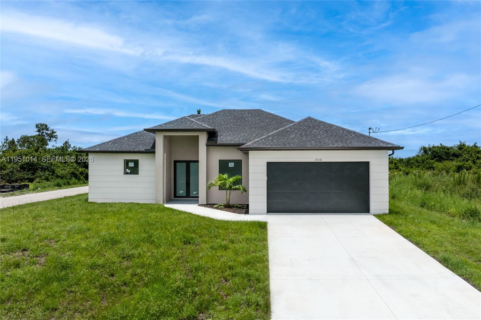 New construction home featuring 3 bedrooms plus a den and 2.5 bathrooms, perfectly situated on a desirable corner lot in Lehigh Acres, Florida. This contemporary residence offers a thoughtfully designed layout that blends comfort, style, and functionality. The home includes three spacious bedrooms and two and a half bathrooms, highlighted by a convenient guest bath with exterior access. A versatile den provides the flexibility to be easily converted into a fourth bedroom or used as a home office. Enjoy the added convenience of a dedicated in-house laundry room. Inside, elegant porcelain flooring flows throughout the home, paired with sleek quartz countertops in the kitchen. The modern kitchen is a true centerpiece, featuring stainless steel appliances, contemporary cabinetry and fixtures, and an impressive waterfall edge island. Ideally located near shopping and restaurants, this home offers everyday convenience in a prime setting. Don’t miss the opportunity to own this beautifully crafted home. Call today to schedule your private showing and make this exceptional property yours.