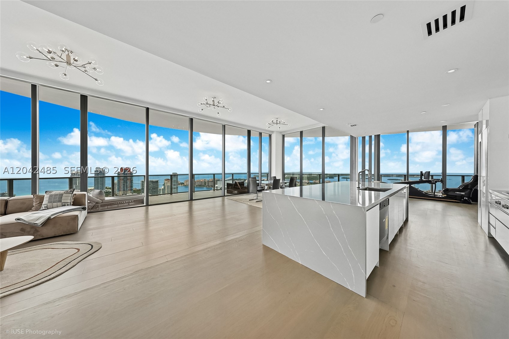 An ultra-exclusive corner residence at Five Park offering 3,200 SF of interior living space and 1,100 SF of wraparound terraces. Positioned on a high floor just below the penthouses, this exceptional home showcases breathtaking 180° views of the Atlantic Ocean, Miami skyline, South of Fifth, and Fisher Island through dramatic floor-to-ceiling glass and soaring 12’ ceilings.
Recently reimagined into a spacious 3-bedroom layout, the residence now features a fully redesigned chef’s kitchen that enhances the flow of the home while opening up even more spectacular skyline views. Thoughtfully upgraded throughout with an Apple Smart Home system, custom-built closets, electric blinds, and a beautifully renovated primary bath.
As part of the exclusive Canopy Collection, residents enjoy privileged access to the private 26th-floor Canopy Club, along with Five Park’s world-class amenities including two resort-style pools, state-of-the-art fitness center, spa, beach club, restaurant, concierge services, and more—all just moments from South of Fifth in Miami Beach’s newest iconic luxury tower.