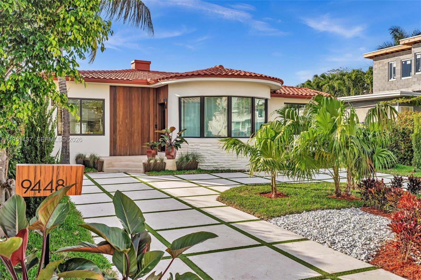 Welcome to this impeccably fully remodeled home, thoughtfully designed by a distinguished French interior designer. Featuring soaring 9.2-foot ceilings, the home exudes a sense of spaciousness and elegance. The Italian-designed kitchen showcases premium quartz countertops, lacquered metal finishes, and state-of-the-art appliances, embodying both style and functionality. Every element of the home has been curated with precision, from the sophisticated lighting fixtures to the organic Japandi paint, ensuring no detail has been overlooked. Nestled in a prime location, this property is just two blocks from the beach, within walking distance of places of worship, and moments away from exceptional dining and the exclusive Bal Harbour Shops. This home is a harmonious blend of luxury, design.