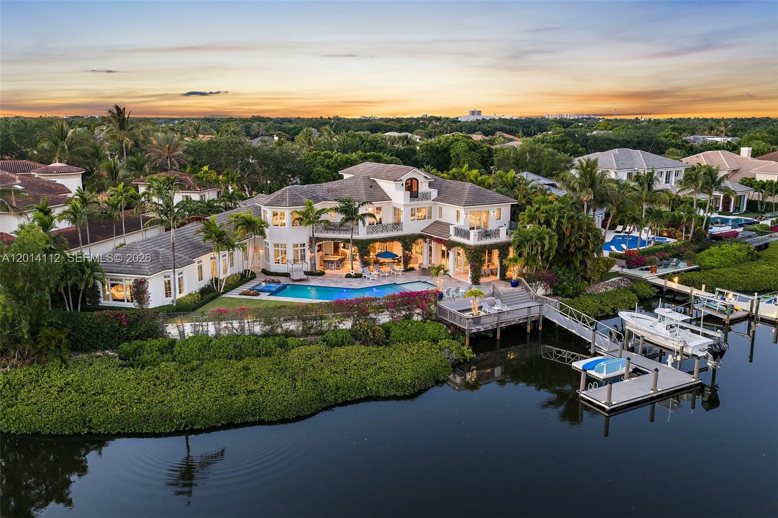 Stunning British West Indies-inspired estate set on a rare point lot, offering over 180 ft of deep, navigable waterfront and exceptional southern exposure with sweeping multi-directional views. This beautifully appointed two-story residence showcases expansive water views, elegant architectural detail, and a seamless indoor-outdoor lifestyle designed for both relaxed living and sophisticated entertaining. 
The home features generous living spaces, a well-conceived floor plan, and refined finishes throughout, complemented by resort-style outdoor areas, a private floating dock, and stunning vistas. Ideally situated within one of the area's most sought-after waterfront communities, Admirals Cove, this property represents a rare opportunity to enjoy premier coastal living.  GOLF MEMBERSHIP available for purchase.