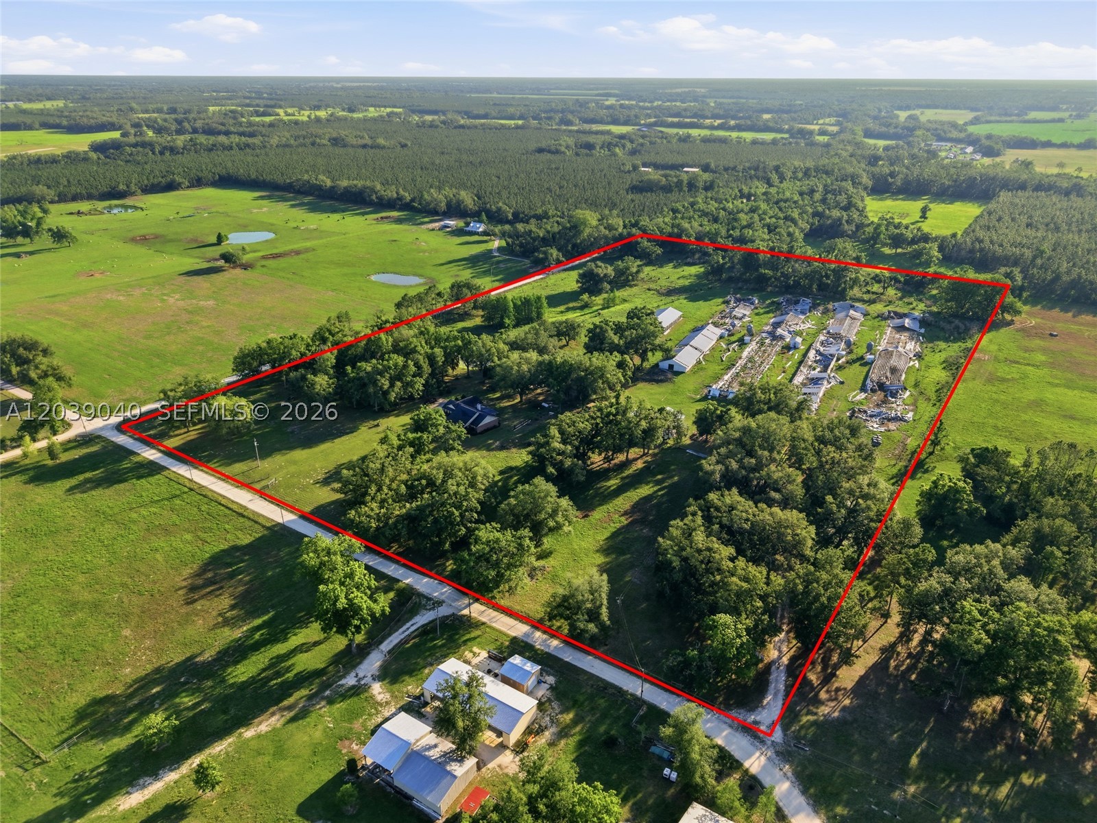 Exceptional 25.03-acre agricultural estate in Live Oak, Florida featuring a well-maintained brick ranch home with approximately 2,178 square feet of living area, 4 bedrooms, 2 full bathrooms, and 1 half bath. Built in 1999, the residence offers a spacious floor plan, fireplace, covered front porch, and covered rear porch overlooking the property.

Designed for agricultural, livestock, homestead, or recreational use, this property includes multiple barns, a barn with attached pole barn, additional pole barn, poultry facilities/chicken coops, storage buildings, fencing, RV hookup, three wells, three septic systems, and four power poles. The property also features a picturesque pond, mature oak trees, open pasture areas, and extensive infrastructure already in place for farming, equestrian, livestock, or rural living.

Zoned A-1 Agricultural and situated on over 25 acres, this unique property offers exceptional versatility for a working farm, family homestead, equestrian operation, investment opportunity, or private country retreat. Conveniently located near Live Oak while providing the privacy, freedom, and functionality of true North Florida country living.

Buyer to verify all measurements, zoning, and intended uses.