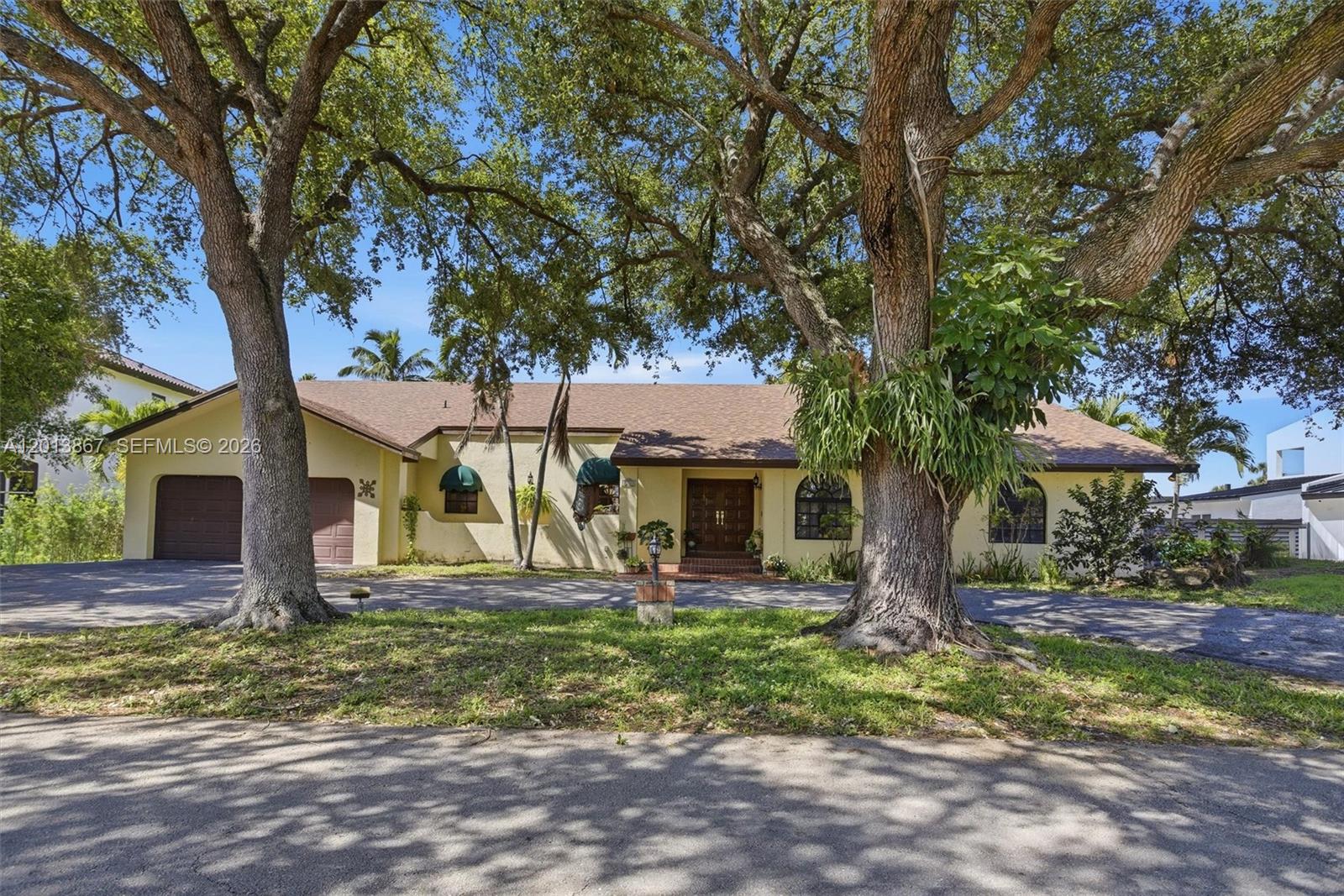 Beautifully situated on a lushly landscaped lot with tranquil golf course views, this spacious residence offers the perfect blend of comfort, character, and South Florida living. Expansive living areas are filled with natural light and seamlessly connect to the outdoor patio and pool, creating an ideal setting for entertaining or relaxing in privacy.  Generously sized secondary bedrooms provide flexibility for guests, family, or office space. Outdoors, enjoy a sparkling pool, covered terrace, and mature greenery that create a true backyard oasis. Additional features include a circular driveway, ample parking, and flex spaces. Conveniently located near shopping, dining, parks, and major roadways, this property offers exceptional space, privacy, and lifestyle appeal.