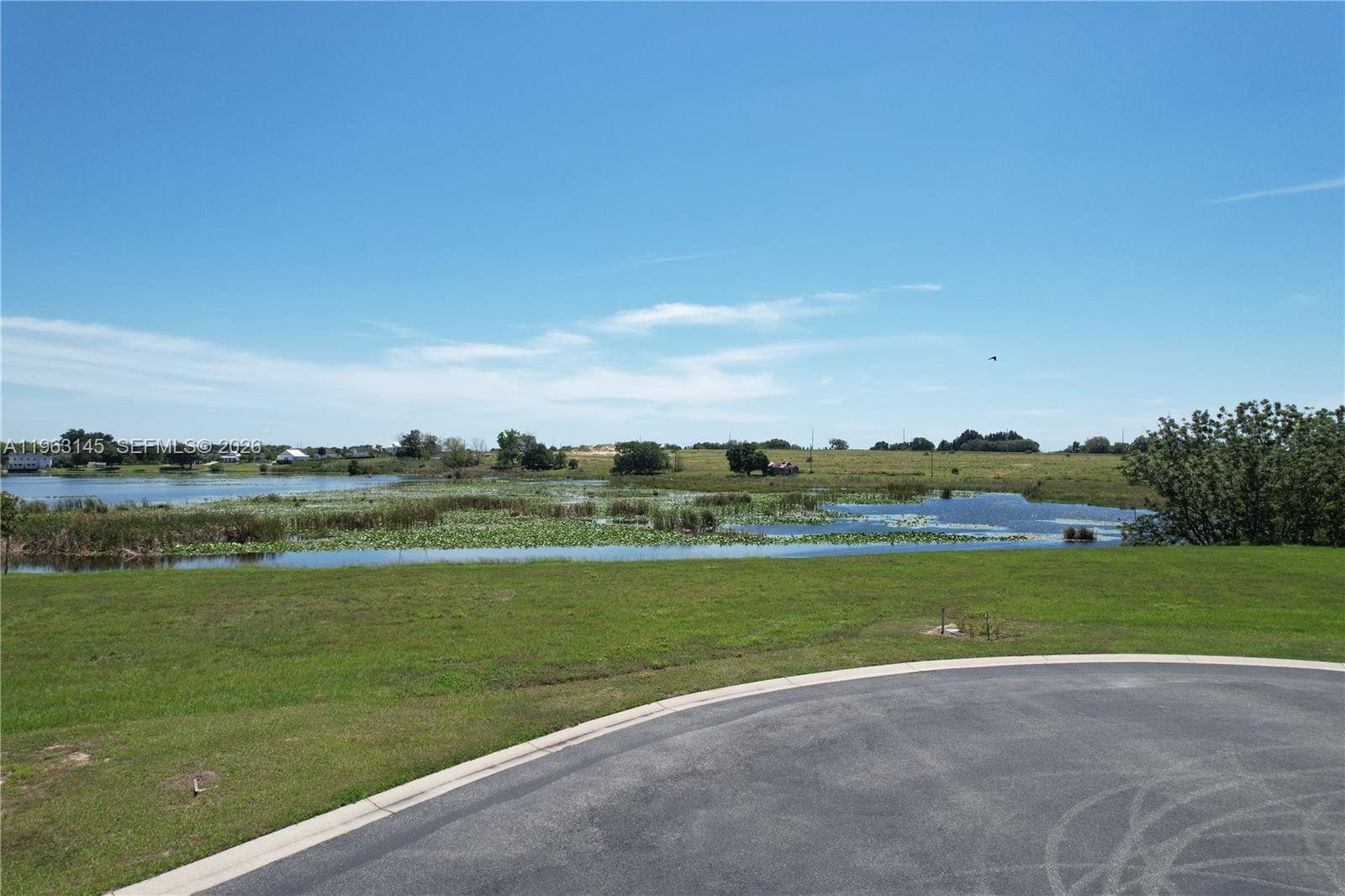 This is a very beautiful lot located within the Water Ridge community, with Lake Alfred front, and ready to build the house of your dreams with an awesome view. Water Ridge is a private gated community, known for its luxurious amenities, three swimming pools, fitness center, clubhouse, tennis courts, boat ramps, and a gazebo with a grill, as well as boat and RV storage facilities, pickleball courts, and a clubhouse.