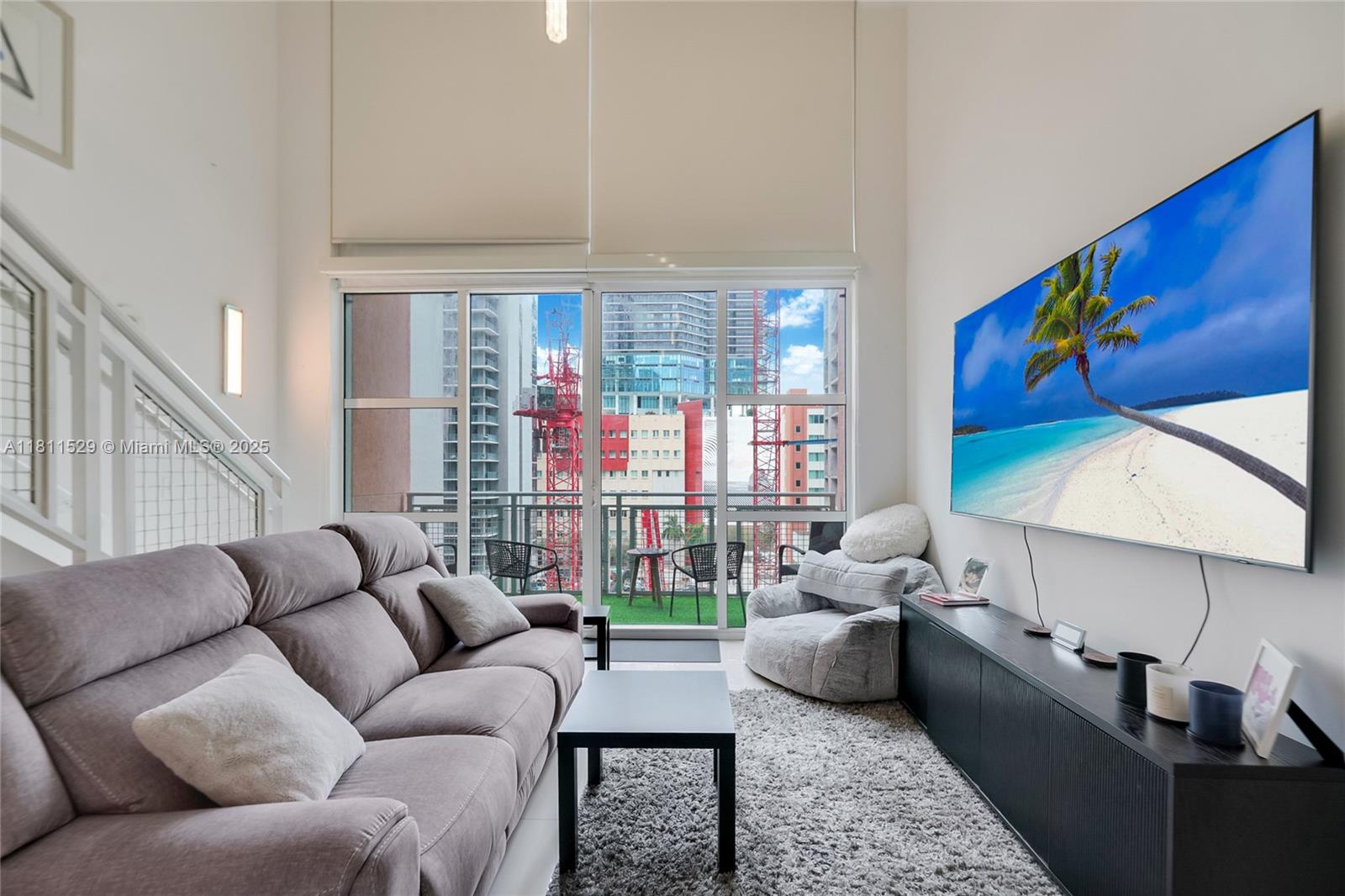 Very nice two-story loft; 1 Bedroom, 1 Full Bath upstairs 1/2 Bath downstairs with 18' floor to ceiling windows; Lounge in the tropical pool while your friends enjoy a massage at the spa or a drink at the wet bar. Building is located directly in front of BAYSIDE; Amenities include: 2 Pools, pool table, media room, conference room, Wi-Fi lounge, running track.