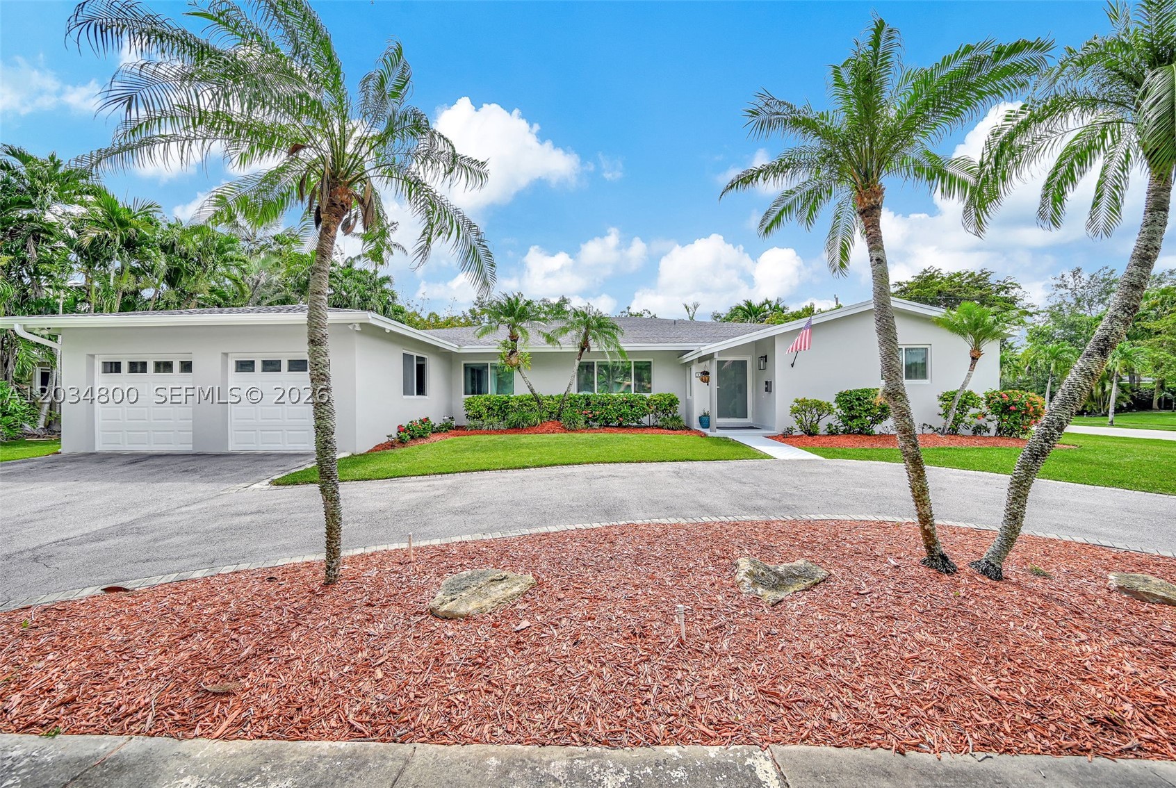 Discover this beautifully updated Palmetto Bay residence offering four bedrooms and three bathrooms on a private 15,000 SF corner lot. Designed for indoor-outdoor living, the home features a sparkling freeform pool with raised spa, expansive covered terrace with tongue-and-groove ceiling, and lush tropical landscaping with mature oak, mango, avocado, and lychee trees. The spacious floor plan offers soaring ceilings, formal living and dining areas, a family room, custom wet bar, and an updated kitchen with quartz countertops, stainless steel appliances, and gas cooking. The luxurious primary suite includes a sitting area, dual walk-in closets, and a spa-inspired bath with smart shower system and soaking tub. On the other side of the house there is a private guest suite with full bath that opens to the patio and pool area. Additional highlights include impact windows and doors, 2019 roof, natural gas, epoxy lined pipes, video surveillance, boat/RV parking, portable generator, and a 2-car garage with separate mud/laundry room.