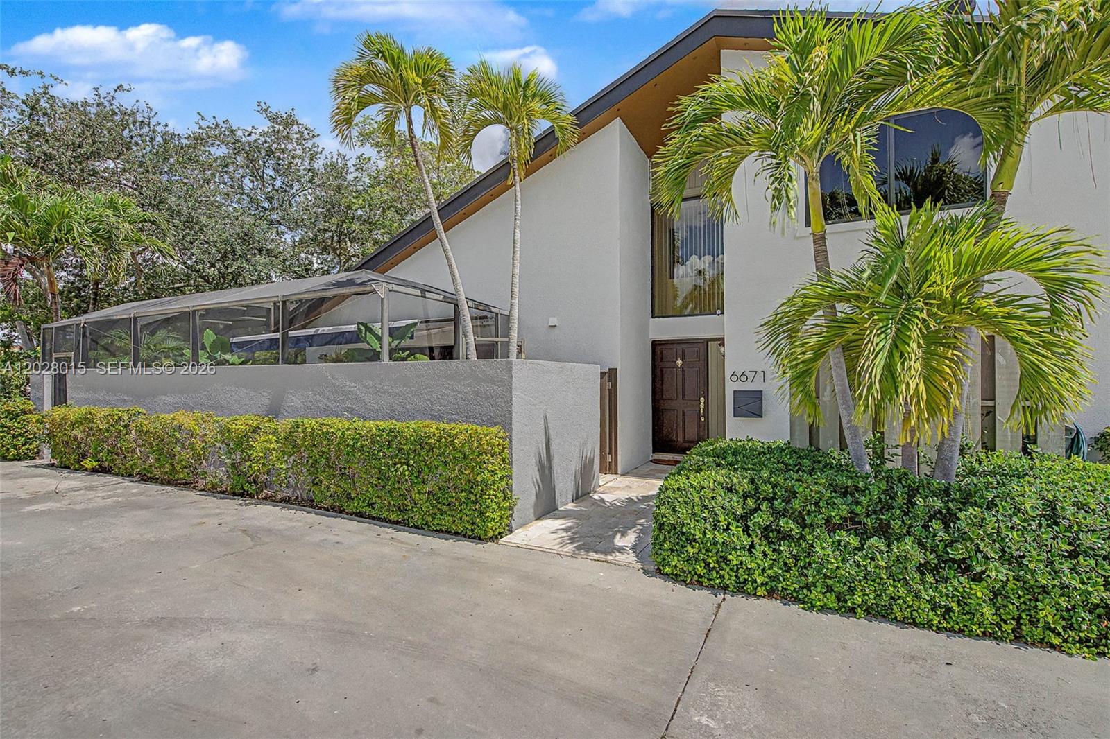 Welcome to this highly desirable corner-unit townhome in the exclusive Banyans of South Miami. Offering 2,200 square feet of living area and the comfort of a single-family home, this spacious residence features soaring 22-foot vaulted ceilings, and a functional floor plan designed for both everyday living and entertaining. The first floor offers three bedrooms and two full bathrooms, along with spacious living and dining areas enhanced by tile flooring throughout the main living spaces. Upstairs, a large loft with a full bathroom and two walk-in closets provides exceptional flexibility and can easily serve as a home office, guest suite, media room, playroom, or an ideal fourth bedroom. Enjoy the privacy of this premium corner location with a beautifully landscaped yard and custom outdoor kitchen, creating the perfect setting for outdoor dining and entertaining. Additional outdoor living space includes a private, cozy lanai ideal for relaxing year-round. Recent improvements include a new roof (2020), impact windows and doors (2021), and an A/C system (2014) featuring a UV light and dual-filtration system. The kitchen appliances were replaced in May 2025, providing added value and peace of mind. The attached two-car garage offers direct private access to the home. Residents enjoy access to community amenities including a swimming pool, gazebo, and tennis courts. The condominium fee covers homeowners insurance, roof maintenance and repairs, common area maintenance, and water.