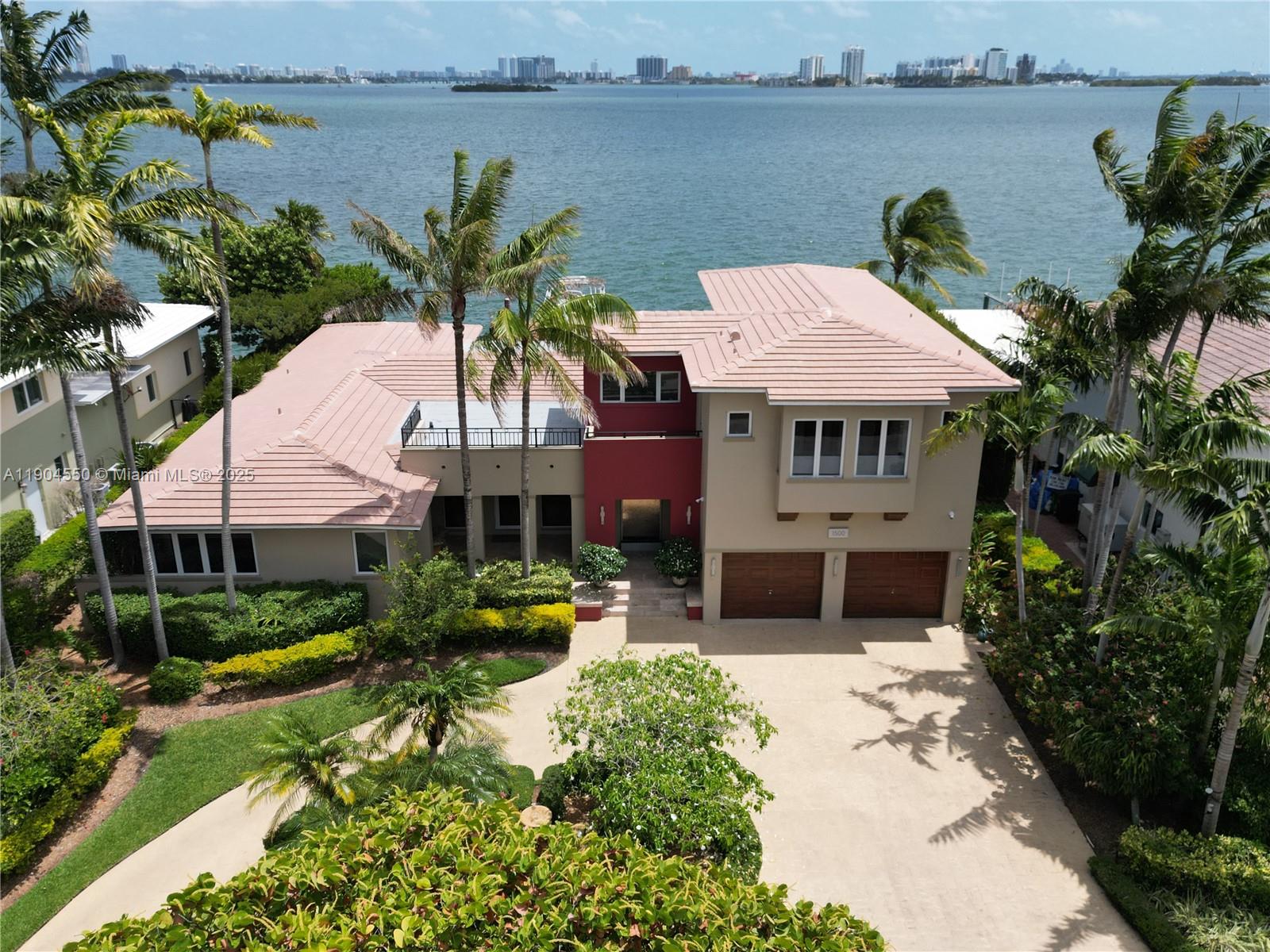 People go on vacation to live like this. Now you can experience dolphins jumping, manatees swimming, and pelicans soaring, every day in your backyard. Reconstructed in 2002, this Miami Shores home offers a wide southern bay view that includes the Miami skyline. The vaulted ceilings, spacious floor plan, and expansive wall of glass doors, blend elegance, nature, and modern living. You will enjoy the upstairs master suite with a spa inspired bath, walk-through closet, and private roof top deck. Entertain in style with an expansive gourmet kitchen featuring a large center island, granite countertops, and a tiled backsplash. And in the morning step outside to the sunrise, take a dip in your private pool and enjoy the bay breezes. We invite you to make this exceptional waterfront home your own.