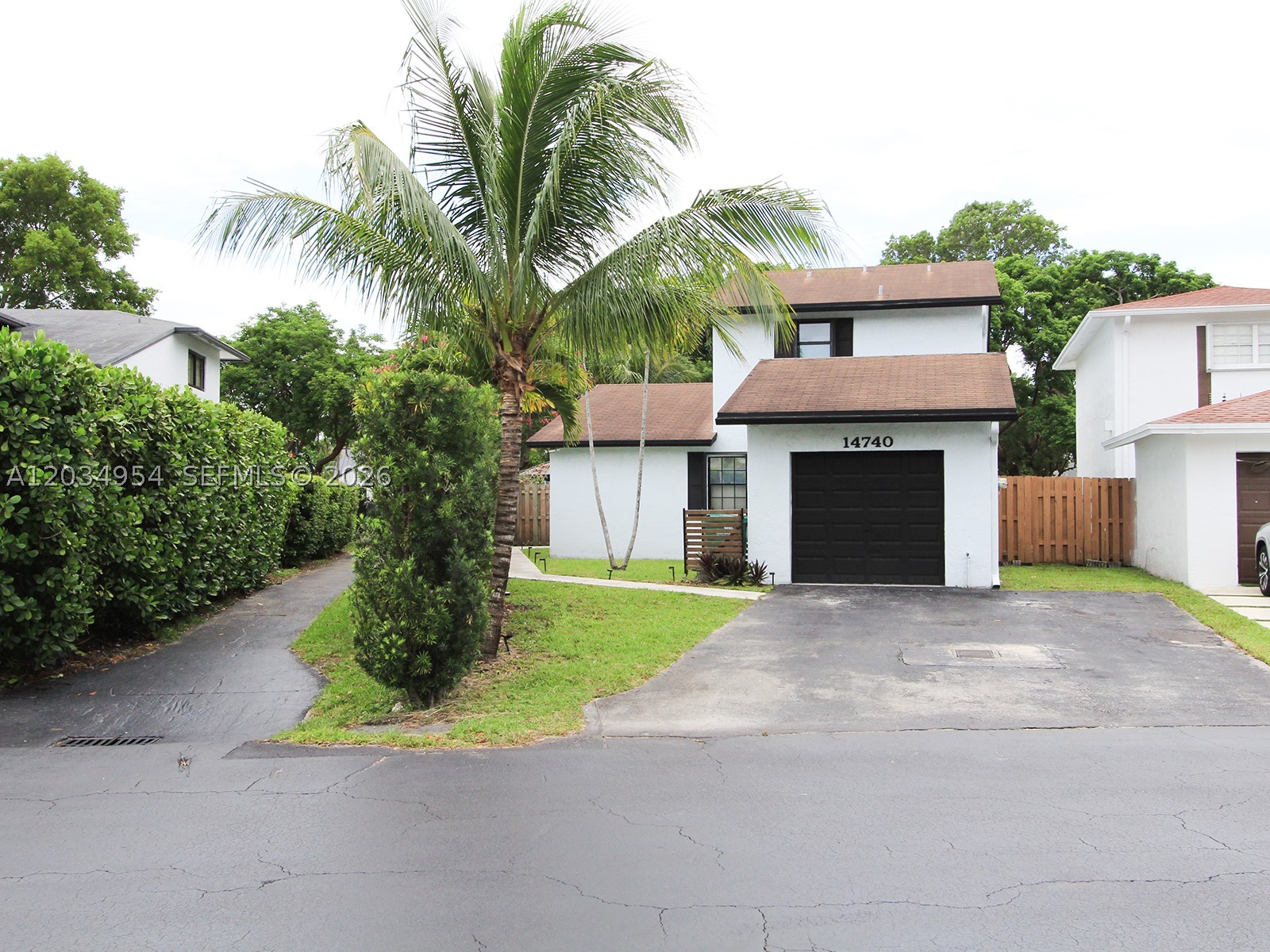 This well-maintained, detached two-story home offers a functional and versatile layout. The spacious master bedroom is located on the upper floor, providing enhanced privacy and comfort. The ground floor features two additional bedrooms, a full bathroom, a kitchen, and a large living room, creating an ideal space for both daily living and entertaining guests. The garage has been converted into an extra room equipped with a portable air conditioning unit, making it perfect for use as a home office, playroom, workshop, or multi-purpose space. Outside, the property offers parking for up to four vehicles and includes a gazebo in the backyard, providing a wonderful setting for relaxation, gatherings, and outdoor enjoyment. Combining comfort, functionality, and outdoor living, this home is an excellent choice for a variety of lifestyles. Plus, benefit from immediate access to lush green spaces, including the hammock park locatedjust behind the house, perfect for leisurely strolls and picnics. This home is a true blend of style, functionality, and convenience.