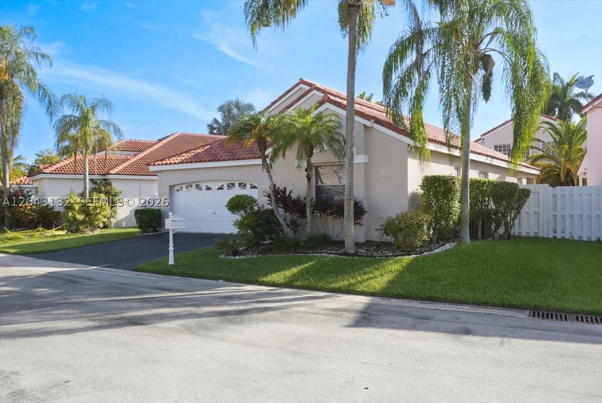 Move-in ready and beautifully maintained, this 3-bedroom, 2-bath home is located in the gated community of Bermuda Springs and offers a bright open floor plan with high ceilings, a desirable split bedroom layout, and comfortable living spaces designed for both everyday living and entertaining. The home features tile flooring throughout the main areas, wood floors in the primary bedroom, laminated floors in the two additional bedrooms, stainless steel appliances, granite finishes in the kitchen and baths, and a spacious dining area with French doors leading to a covered patio and fenced backyard. The primary bathroom includes a double sink, a separate shower and bathtub, and a linen closet for added convenience. The laundry room is located inside the house and includes a full-size washer and dryer. Additional highlights include a 2-car garage, electric charger, protective shutters, fresh interior and exterior paint, a roof replaced in 2020, and a new electric panel in 2026, offering added peace of mind and value. Residents of Bermuda Springs enjoy a well-kept community with a pool and child play area, while the home’s location in Weston provides access to highly regarded schools, nearby shopping and dining, beautiful parks, bike paths, and a strong sense of community.
