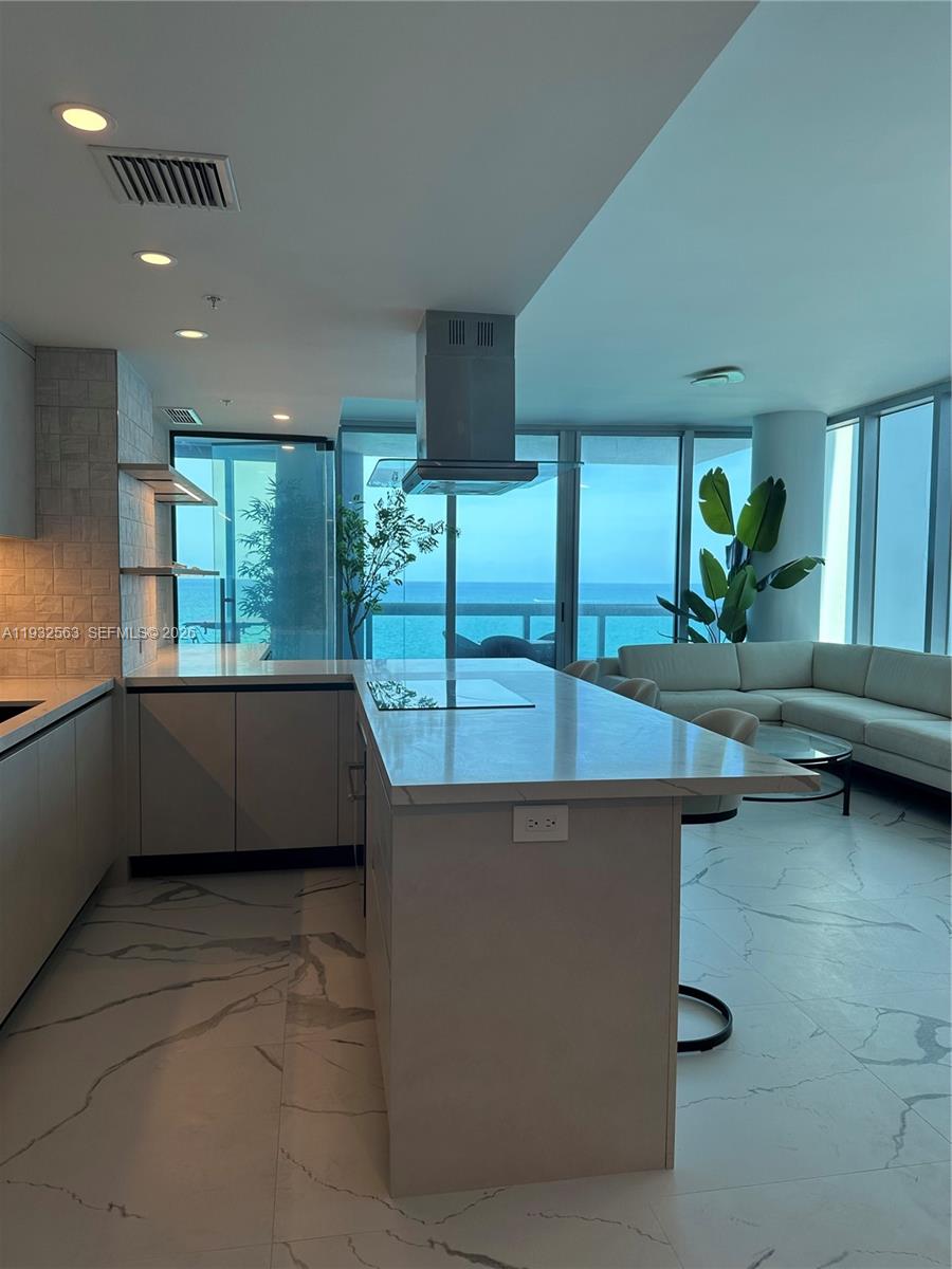 Live the ultimate ocean view lifestyle in this impeccably renovated 2 bedroom, 2 bath corner residence at the prestigious Carillon Miami Wellness Resort North Tower. Completed in 2024, this stunning home features a full, no-expense-spared renovation blending modern luxury with serene coastal living.

Floor to ceiling custom windows, with electric blackout at the touch of a button, fill the home with natural light and frame breathtaking Atlantic sunrises. Step onto your private oceanfront terrace to enjoy morning coffee with the sound of the waves or relax as the sky transforms at dusk. Sleek tile flooring flows throughout the interior and balcony, enhancing the clean, contemporary design.

The open-concept chef’s kitchen impresses with top-of-the-line appliances, custom lighting, and bespoke cabinetry. Refined finishes continue throughout. The primary suite boasts a truly astonishing direct ocean view, with the tenth floor location offering engagement with the beach, making every morning feel like living in a retreat.

Residents enjoy five-star resort living with access to Carillon’s award-winning 70,000 square foot spa and fitness center, four oceanfront pools, private beach service, valet, concierge, 24-hour security, dining and lounge options, and 100+ weekly wellness classes.

Ideally located near Bal Harbour Shops, dining, cafés, groceries, and the Miami Beach boardwalk, this residence offers luxury, wellness, and convenience in one exceptional oceanfront home.