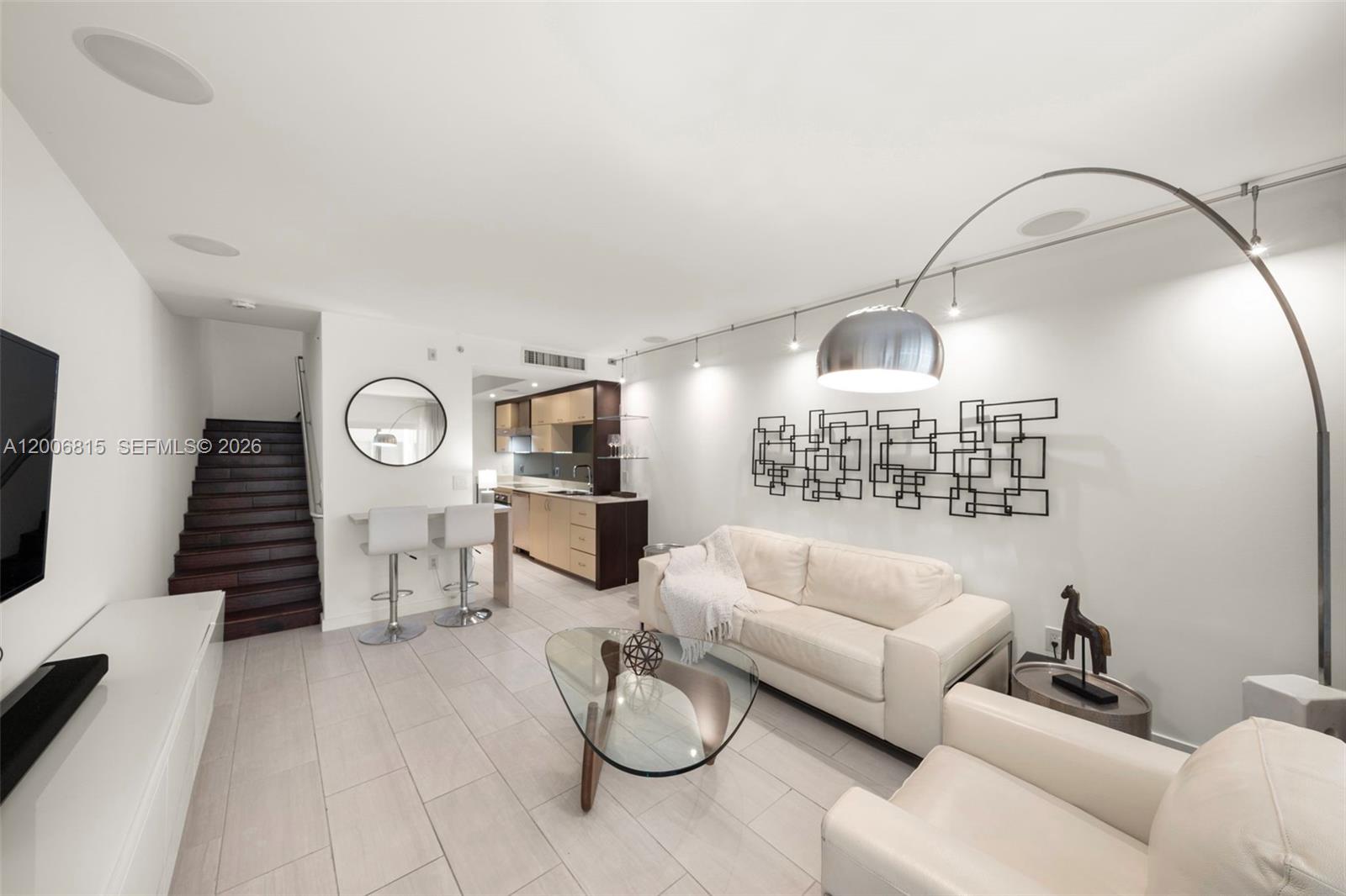 Live the South Beach lifestyle in this sleek two-story 1-bed, 1.5-bath townhouse at Artecity. This upgraded residence feels bright and airy, featuring high ceilings and oversized windows that flood the space with natural light. The home is fully tech-optimized with a custom integrated Sonos sound system, designer lighting, and motorized window treatments throughout. The modern kitchen is equipped with premium stainless steel appliances, making it perfect for daily living and entertaining.

Living at Artecity feels like a permanent vacation, offering two lush pools, a fitness center, 24-hour security, and valet. Best of all, enjoy the ultimate Miami Beach perk: complimentary beach service (chairs and umbrellas) at 21st Street. Located just blocks from the sand and the best dining in the Cultural District, this is the perfect tech-forward retreat in the heart of South Beach.