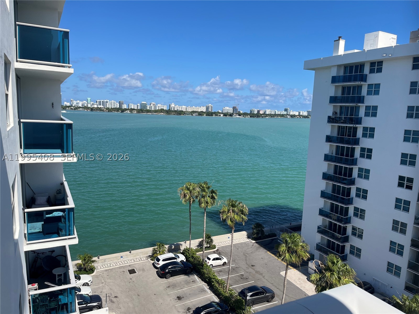 You need peaceful quiet living?  You have found it here. Absolutely terrific sun-drenched South facing 1/1 right on Biscayne Bay with a gorgeous view from Biscayne Bay to the east and west.  Super quiet location with NO noise from 79 Street to the North. Enjoy basking in the sun on your patio from the moment you awake in the morning til mid afternoon.  You will enjoy BOTH sunrises and sunsets from your spacious patio. Enjoy cool breezes year round as our building is on the southeastern corner of Treasure Island. Hurricane windows and engineered wood floors throughout the apt. Located right up the street from a brand new Publix being built, and the exciting Argentinian Football Association center, and across the street from A rated Treasures Elementary School. Building is in the final stages of painting and concrete restoration. New elevators are being installed. Owner will be paying assessment. Owners have access to great gym and pools. Laundry center is right outside the apt and super convenient. This is a great opportunity to get into booming North Bay Village at a very affordable price, before the next phase of city construction is completed.