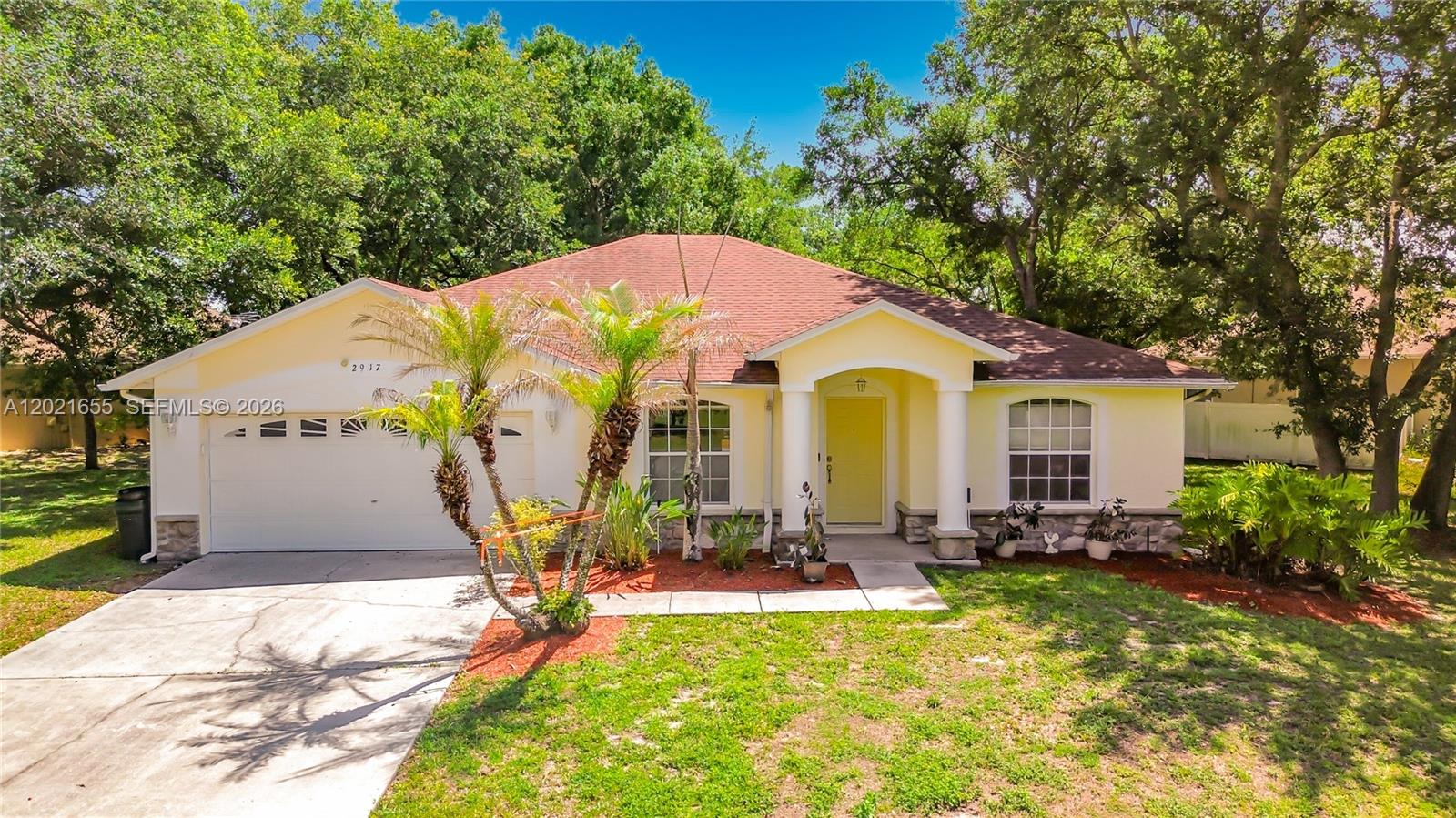 Welcome to 2917 Evans Way in Doral Woods! This beautiful 3BD/2BTH home with a Flex Room that can easily serve as a 4th bedroom or home office also features a 2 car garage and sits on one of the largest lots in the neighborhood at .42 acres. With plenty of room to expand or build a pool, the possibilities are endless. Located in a quiet community, this well-maintained, move in ready home features a roof replaced in 2018, A/C and Condenser approximately 2 years old, and a septic system professionally drained and serviced in 2026. Interior updates include new Corian kitchen countertops, a new sink, gas range, and newly installed wood look tile flooring throughout the main living areas, with carpet in the bedrooms for added comfort.  The guest bathroom offers convenient direct access to the covered patio, making it ideal for future pool plans. Enjoy relaxing outdoors under the covered patio surrounded by lush trees and greenery, creating a peaceful and private retreat. Best of all, there's no HOA approval required & no CDD fees.