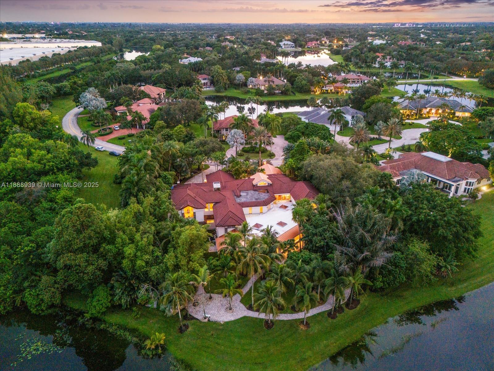A world of prestige and power awaits in Weston’s Windmill Ranch Estates. Positioned on a commanding 50,000+ sq ft lakefront setting, this Presidential-inspired residence spans over 11,000 sq ft with 7 ensuite bedrooms and 8.5 baths. Extraordinary amenities include a replica Oval Office, private cinema, cigar lounge, art gallery, game room, children’s wing, gym, and collector’s garage. A striking Asian-inspired salon anchors the expansive family room, while an indoor pool invites year-round enjoyment. Designed for effortless entertaining across both formal and casual spaces, this estate boasts impact glass, quality construction, and a 2014 roof. A rare offering for the discerning buyer seeking true privacy, scale, and architectural distinction in Weston’s most exclusive enclave.