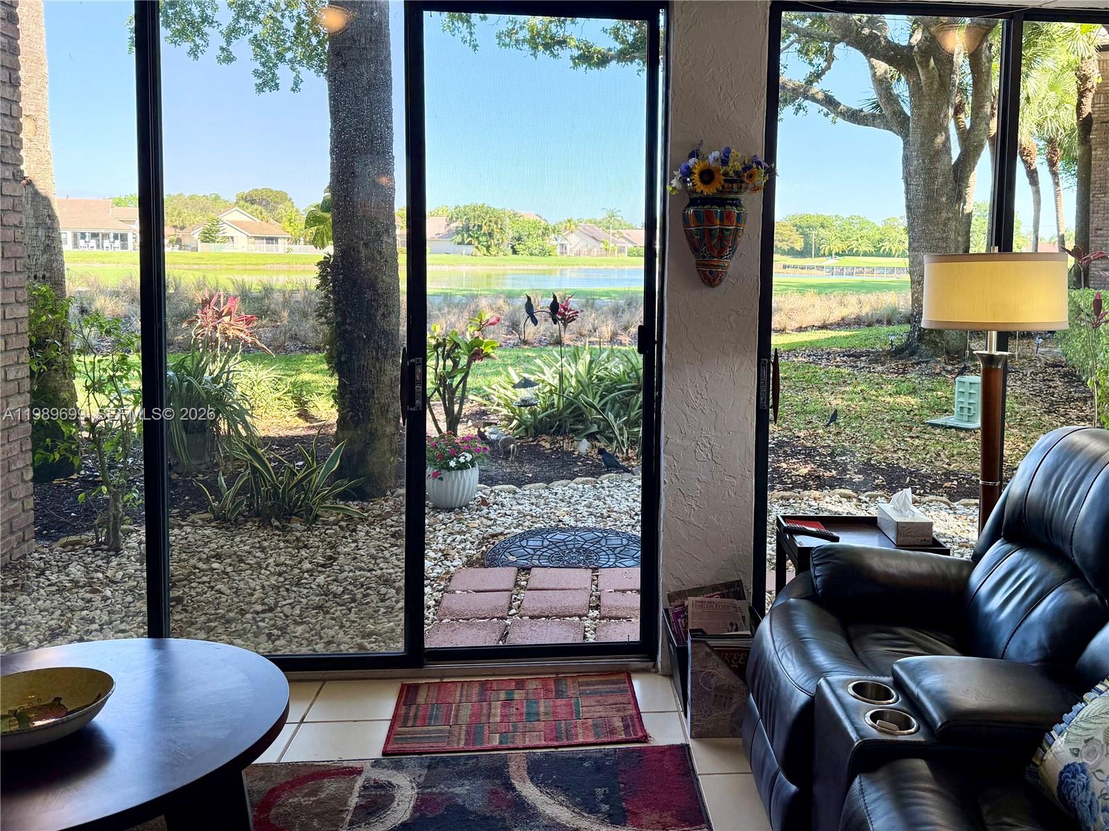 Experience panoramic golf and lake views from this rare corner residence in Aberdeen Golf & Country Club. Designed for natural light and seamless indoor-outdoor living, this home features oversized windows, elevated ceilings, and a glass-enclosed lanai that creates a year-round space to relax & enjoy the scenery.

The open kitchen is positioned to capture the tranquil fairway, 8th hole, & water views, complete with quartz countertops, white cabinetry, & a spacious breakfast bar that flows into the main living area. The primary suite offers a large walk-in closet & picturesque views. Hard flooring runs throughout with no carpet, creating a clean & low-maintenance interior.

Recent updates include a brand new A/C, hot water heater, and stacked washer & dryer. First-floor access & parking directly in front of the unit add everyday convenience, with guest parking nearby. The building has also been recently painted & features a newer roof.

Located within exclusive Aberdeen Golf & Country Club, a mandatory membership community, residents enjoy access to Jim Fazio-designed golf course, tennis, pickleball, resort-style pools, a state-of-the-art fitness and aquatics center, and multiple dining venues. A vibrant social calendar creates an active, connected lifestyle.

Situated within an A-rated school zone & set across 1,400 acres of beautifully maintained grounds, Aberdeen offers a rare opportunity to enjoy true country club living at a compelling value in Palm Beach County.
