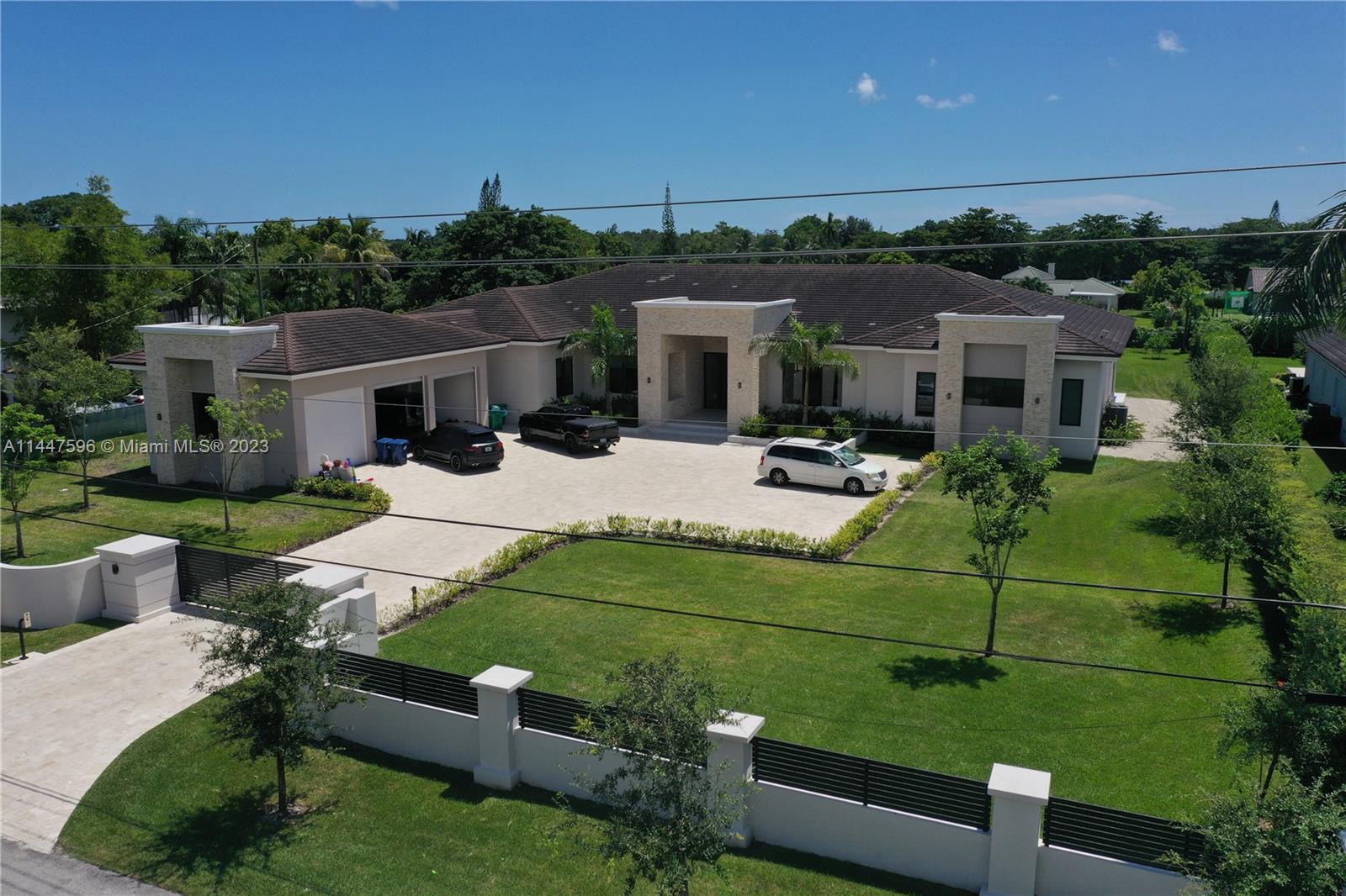 This custom residence is nestled on a completely gated 50,094 sf lot boasting a split floor plan with 6 bedrooms and 6.5 baths. The Primary Suite spans over 1,500 sf with a large sitting area, 2 separate walk-in closets, and a spa-like bathroom. 14ft ceilings throughout with floor-to-ceiling windows overlooking multiple massive covered terraces and pool with spa. This property also features a media room with a wet bar for easy entertaining. Additional amenities include a gym, 3-car garage, and a covered terrace with a summer kitchen.