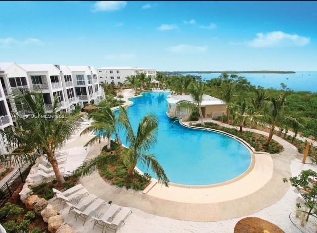 Perfect Florida Keys townhouse with proven Rental Income!  Located in resort style Mariners Club Key Largo - gated community,  unit offers a unique opportunity to rent as a 4 bedroom/4 bathroom or a 2 bedroom/2 bathroom!  Recently painted & some upgrades in downstairs unit, turnkey & low maintenance with 5 years of rental history on VRBO.  Community Marina offers deep-water dockage, 2 oceanfront pools, 24-hr security, game room,  community grills, tennis, pickleball, basketball, gym, & more!  Boat dry dock storage & Jet ski storage available (Costs managed by HOA). No rental restrictions - manage independently or through a property manager.  Pet friendly community for owners.