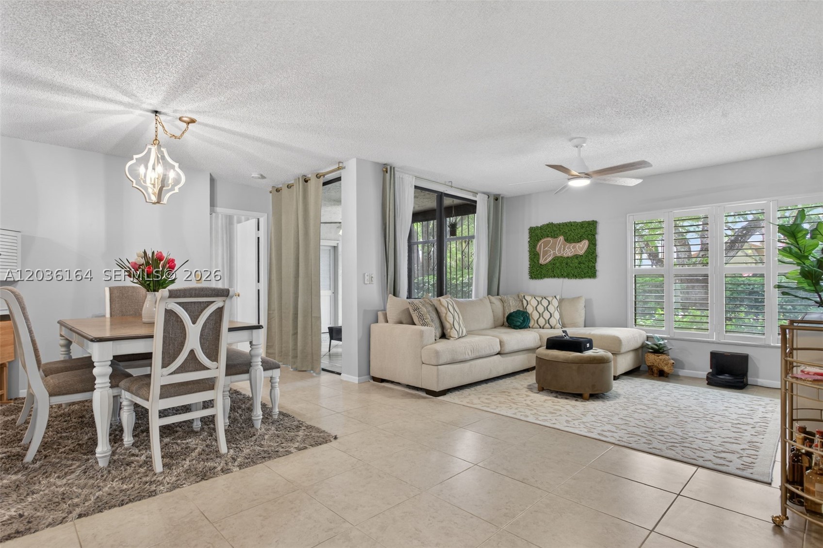 Welcome home to this spacious, beautifully updated ground-floor corner-unit condo in Applewood Village III. This 3-bedroom, 2-bath residence offers over 1,100 sq. ft. of comfortable living space with a split-bedroom floor plan, abundant storage, and generous closet space. The community features new roofs, and this unit’s 15-year roof assessment is paid in full! Enhanced cable is included, with fiber internet coming in October 2026. The open layout features tile and water-resistant laminate flooring throughout. The large primary suite includes an extended walk-in closet and updated shower. The kitchen offers wood cabinetry and new stainless steel appliances. Additional highlights include a new washer and dryer, plantation shutters, screened windows and doors, and a screened patio with a weatherproof enclosure. Amenities include an assigned parking space, ample guest parking, and access to a private community pool and clubhouse with free party rentals. Residents also enjoy The Township’s resort-style amenities, including an aquatic center, lap pool, children’s pool, hot tub, saunas, playground, fitness center, pickleball, tennis, basketball, racquetball, sand volleyball, shuffleboard, bocce ball, performing arts center, ballroom, picnic areas, scenic boardwalk trail, and more. Ideally located within walking distance of Butterfly World, Tradewinds Park, and the local farmers market, and just minutes from shopping, dining, and entertainment at The Promenade at Coconut Creek.