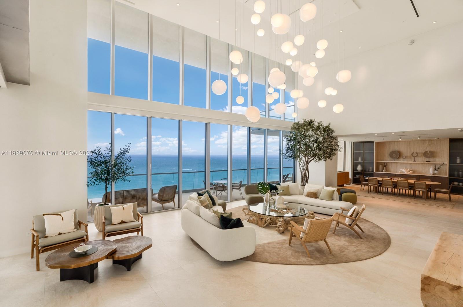 Discover the Sky Villa, a limited-edition corner flow-through duplex at Turnberry Ocean Club Residences, offering 11,035 SF of indoor/outdoor living. This turnkey residence features breathtaking Ocean & Bay views, 20’ ceilings in the living area, and 10-11’ ceilings throughout. The Snaidero chef’s kitchen boasts Taj Mahal Quartzite countertops, Gaggenau appliances, and Dornbracht fixtures. The primary suite includes custom Italian furnishings and a spa-like bath with Silver Travertine slabs and a Studio LOHO freestanding tub. The 4,340 SF oceanfront terrace offers a private pool, hydrotherapy spa, and summer kitchen. Additional features include an office and staff room. Turnberry’s luxury amenities include the exclusive Sky Club with sunrise/sunset pools, private dining, and wellness spa.