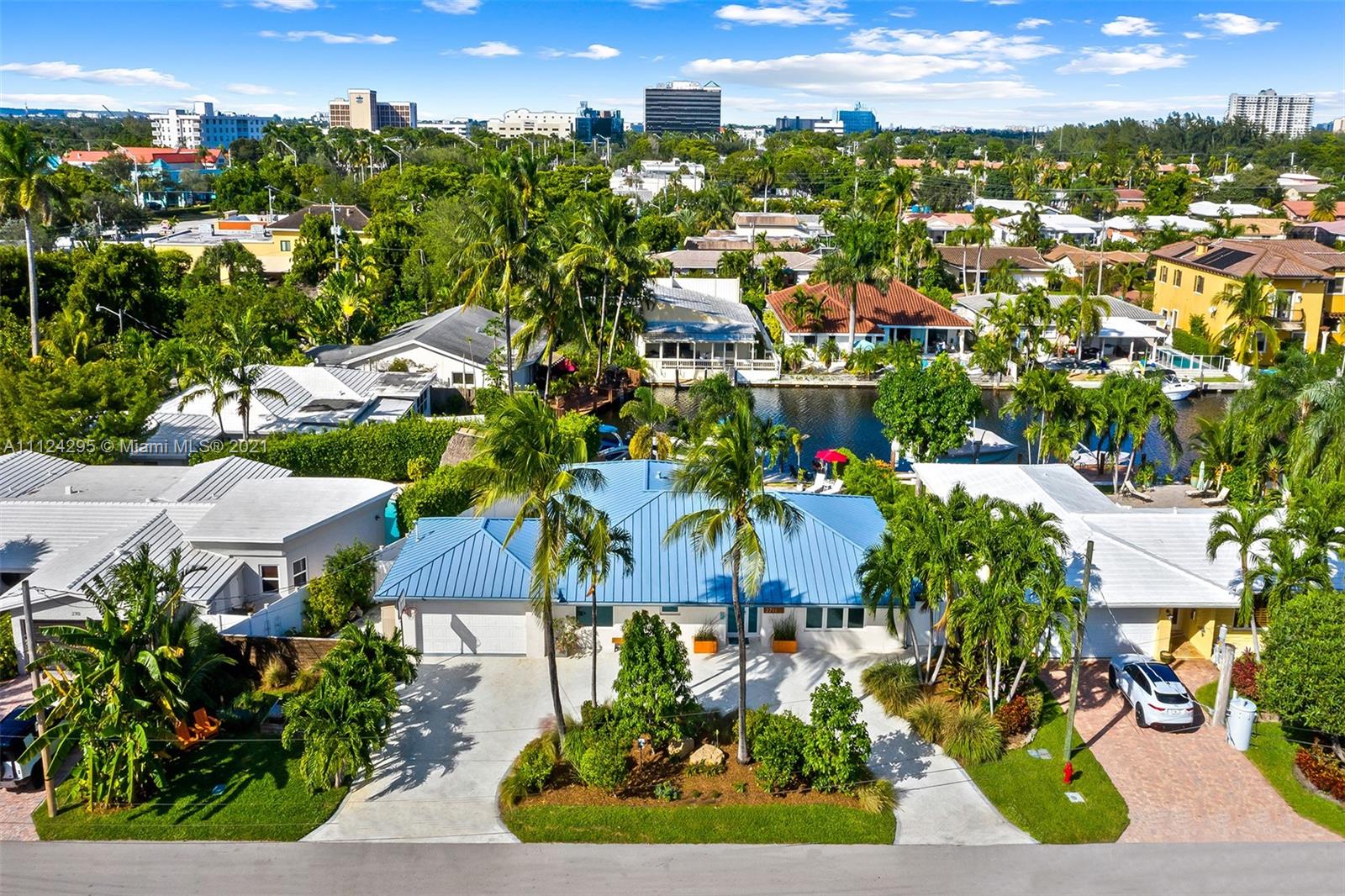 Stunning updated home with 55 feet of tranquil waterfront in East Fort Lauderdale’s sought after Lake Estates neighborhood. Step inside to an open and spacious kitchen which flows between the living and dining room. Recently updated kitchen with new SS appliances, including a double convection oven, reverse osmosis system, wine refrigerator, quartz countertop and windows overlooking the salt water pool and canal. Bright and light from every room, tile flooring, and hurricane impact windows accentuate the beauty of this home. This 4 bed 2 bath home features: 14,000 lb boat lift, dock, pilings, and seawall done in 2016, metal roof, new AC 2021, 2 car garage w/ charge point level 2 charger, pool deck pavers completed in 2018, & a circular driveway. This is a home you don’t want to miss!