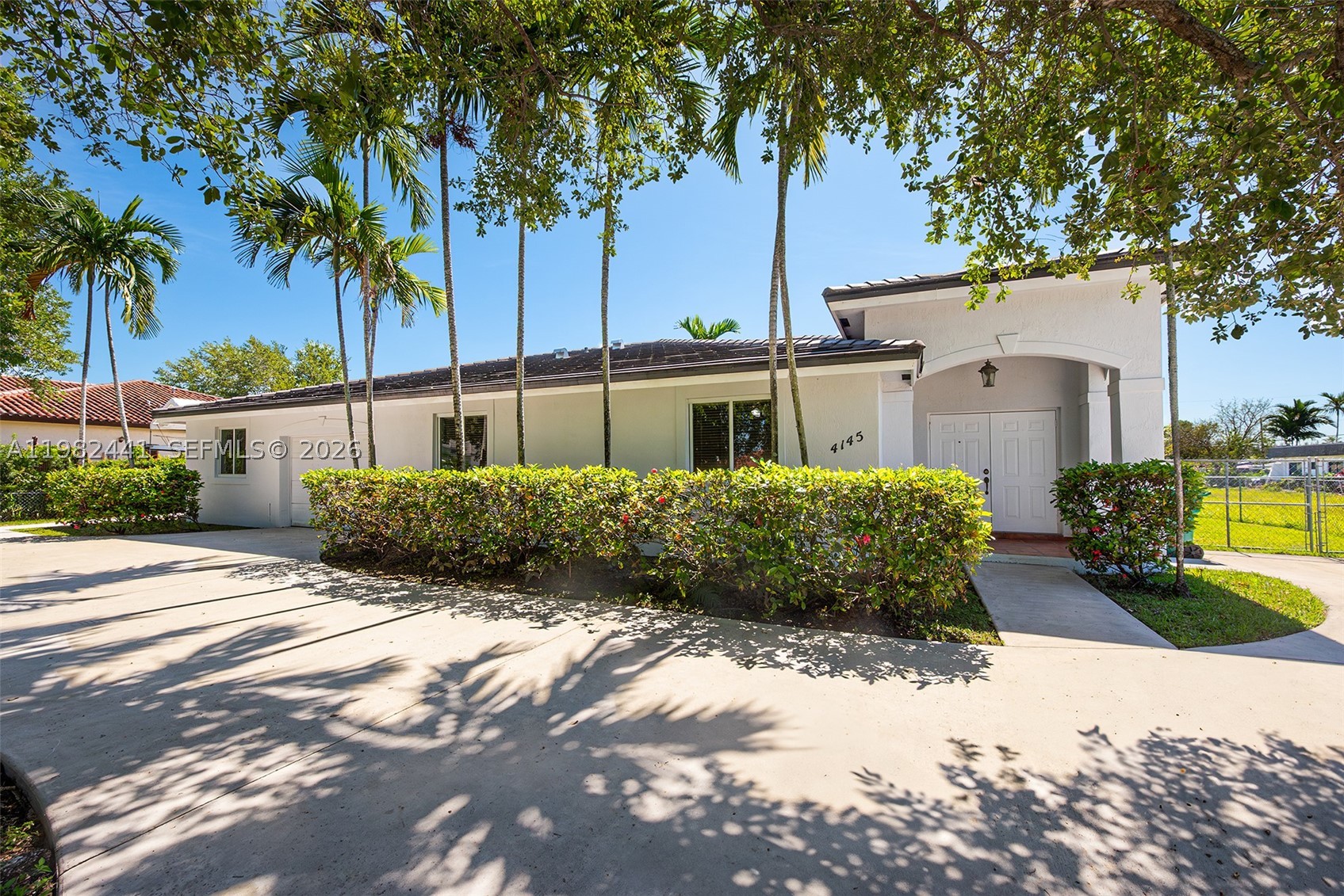 Welcome to this turnkey 4-bedroom, 3-bath home on a 16,934 sq ft lot (approx. 100’ x 160’ per survey). As you walk in, you instantly feel at home. It is a well-designed layout with great flow between living, dining, family room, and kitchen, all overlooking the backyard. The house is filled with natural light throughout. Comes with two en-suite bedrooms, including a private suite with separate entrance, which is ideal for guests or in-laws. The primary bedroom is large and features two walk-in closets. All bedrooms are spacious with ample closet space. Recent updates include a 2023 roof, impact windows and doors, freshly painted interior and exterior, and a brand-new washer. Additional features: one-car garage, indoor laundry, a lot of front parking with large driveway in front and an extra-wide side yard with room for RV or boat. Also includes a convenient side storage room for extra storage space. The backyard is large with plenty of space for a pool and outdoor living.  You can also enjoy a nice sized patio area perfect for relaxing or entertaining. Property qualifies under Miami-Dade guidelines to add an auxiliary dwelling unit (separate guest house) at the rear. This property is also located in a great location near major expressways, restaurants, shopping and more. Photos with furniture have been virtually staged for illustrative purposes. Photos with furniture have been virtually staged to illustrate the potential of the home.