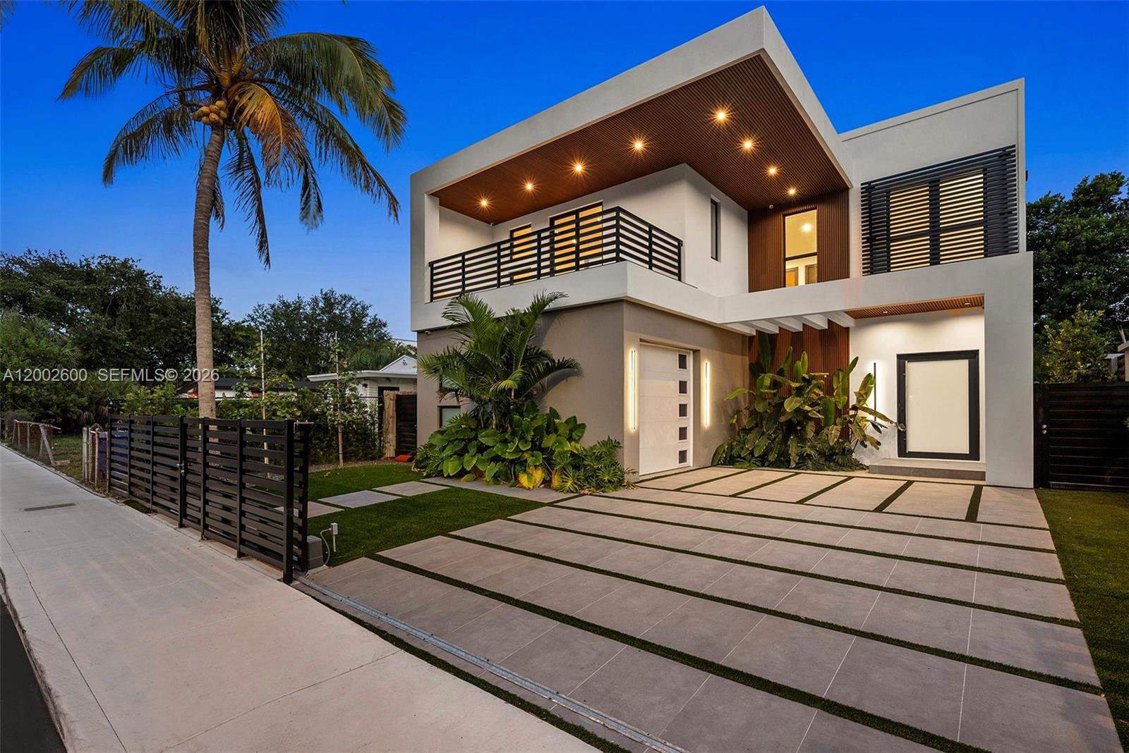 This striking modern residence in Buena Vista offers a seamless blend of luxury, design and functionality set on a fully gated lusciously landscaped property. Featuring soaring 25 foot ceilings and dramatic floor to ceiling windows, this smart home is filled with natural light and showcases elegant oak flooring, custom cabinetry, top of the line appliances and a 192 bottle wine cellar. The open concept layout includes a chef's kitchen adorned with Taj Mahal stone, flowing into spacious living and dining areas ideal for entertaining. Upstairs four generously sized bedrooms include a lavish primary suite with dual closets, a spa inspired bathroom and private balconies. Generous outdoor living spaces designed for enjoyment, featuring a heated pool and spa, alongside a sleek stainless steel kitchen. Just minutes from Miami's Design District, Downtown and the beaches.