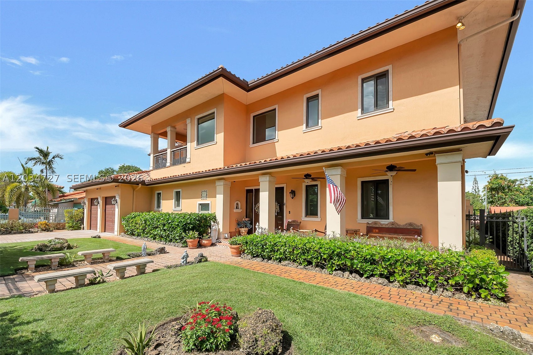 A Home of Distinction! Mediterranean-style, Cuban-inspired 2017 custom estate in sought-after Little Gables. Built with solid concrete block, a concrete roof, and Spanish "S" tile, this fortified home, beautifully combines timeless luxury with maximum security, safety, and modern conveniences. Infrastructure upgrades include full impact doors and windows, a gas-powered Generac generator with an underground tank, closed-cell foam insulation, and a water cistern system. The 3,736 sq. ft. living area (3,932 adjusted sq. ft.) boasts a dramatic entry foyer with expansive volume ceilings, detailed flooring, custom iron railings, authentic Cuban tile floors, and exceptional woodwork carpentry throughout. The designer chef’s kitchen features floor-to-ceiling custom cabinetry, premium stone countertops, an oversized walk-in pantry, and generous workspace tailored for entertaining. The flexible layout offers 4 large bedrooms and modern baths with premium finishes and walk-in tubs, highlighted by two main owner’s suites (one ground-level with a walk-in closet). Also includes separate maid’s quarters, laundry room storage, and a dedicated tool room. The outdoor oasis affords casual living with two spacious covered terraces, manicured gardens, a relaxing jacuzzi, and a rear patio with mature fruit trees. A rare find! Ideally located just minutes from Downtown Coral Gables, Miracle Mile, Brickell, and Downtown Miami. Schedule your private showing today!