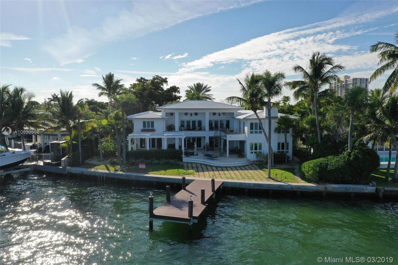 Bran new modern white concrete tile roof & exterior white paint job transform the look & feel of this bayfront estate. Exemplary gated home on the wide bay w 120ft of unobstructed views & downtown MIA skyline. Privacy gated entrance w/ sweeping driveway & plenty of parking. 2-level patio w pool, pergola, & summer kitchen. Grand family room w volume ceilings is perfect for entertaining w/ private exit to second floor terraces. Grand family room has wet bar, custom built-ins, & reclaimed chestnut hardwood flooring. XL Master suite has his/hers walk-ins, spa bath, & private access to outdoor terrace. Chef's kitchen has gas cooking & adjacent dining room. Grand foyer entry w/ bonus dining room off courtyard. Full back-up generator and new boat dock. Private garden, exercise room w/ dry sauna.